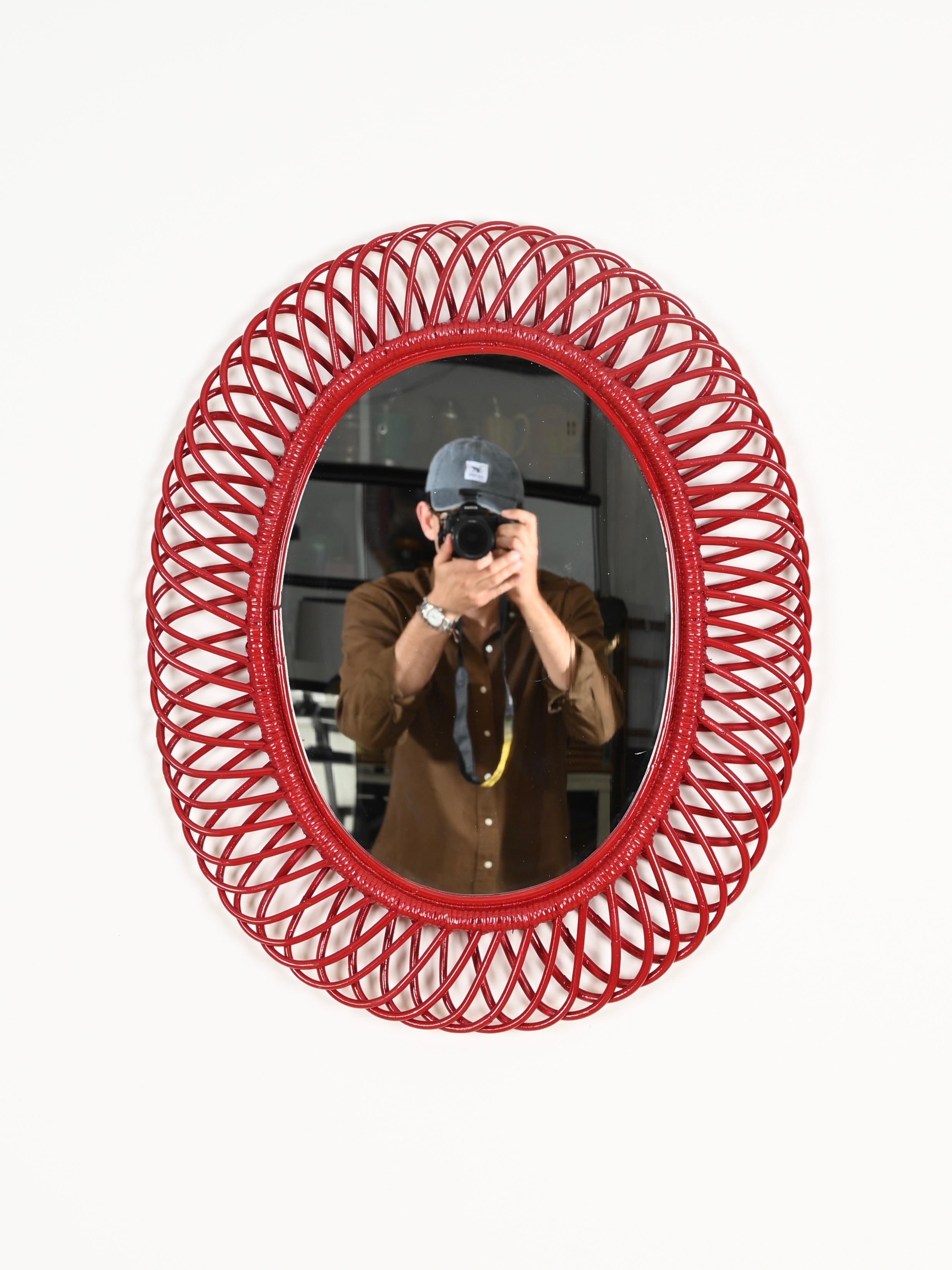 Stunning Mid-Century Italian oval mirror in curved rattan, bamboo and hand-woven wicker. This delightful French Riviera style mirror was designed by Franco Albini in Italy during the 1970s.

This beautiful mirror is in amazing conditions and is