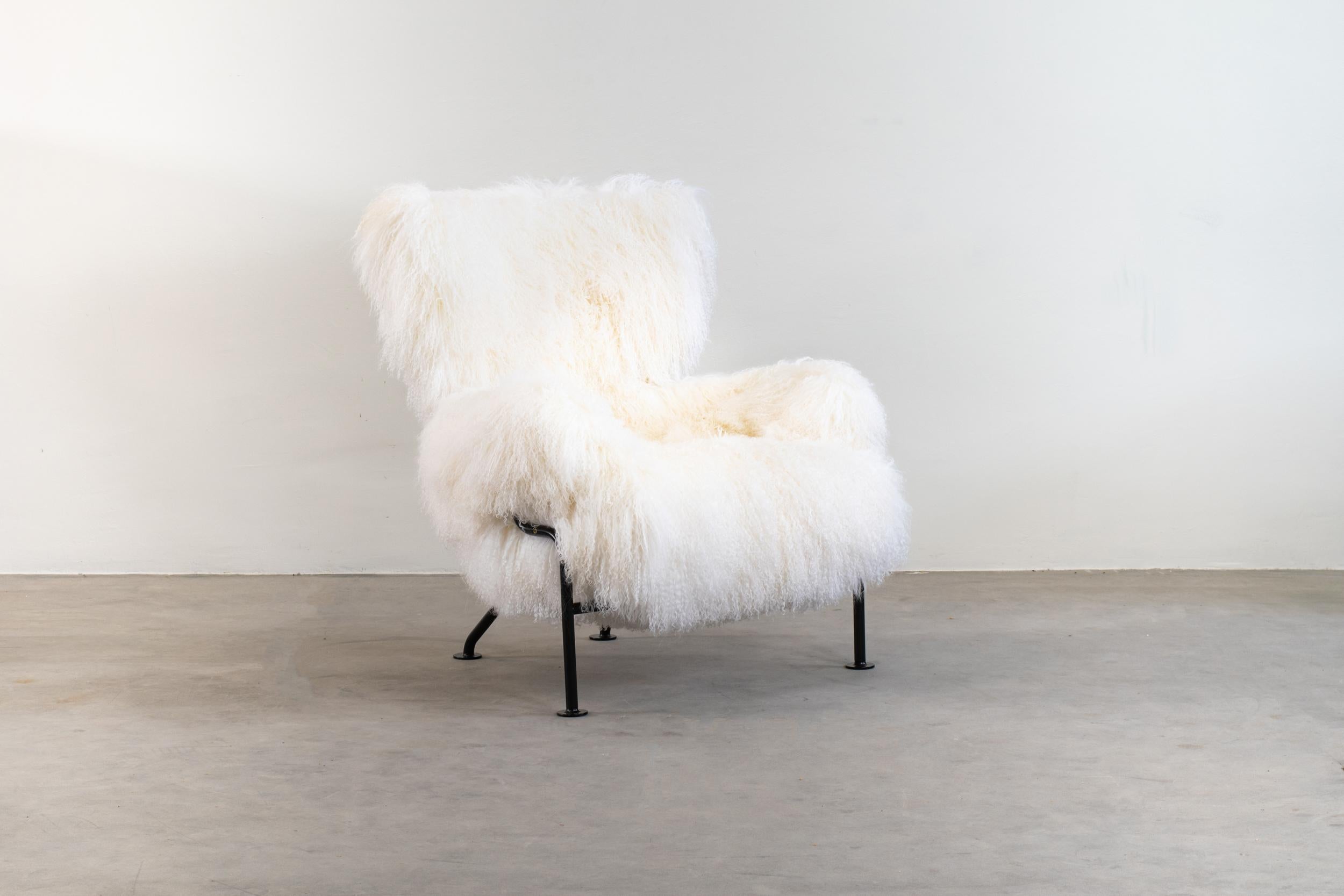 PL19 also known as Tre Pezzi armchair with black enameled steel tube structure, upholstered in white Mongolian goat wool. 

Designed by Franco Albini & Franca Helg for Poggi, Pavia produced since the late 1950s to 1970s.

After spending his