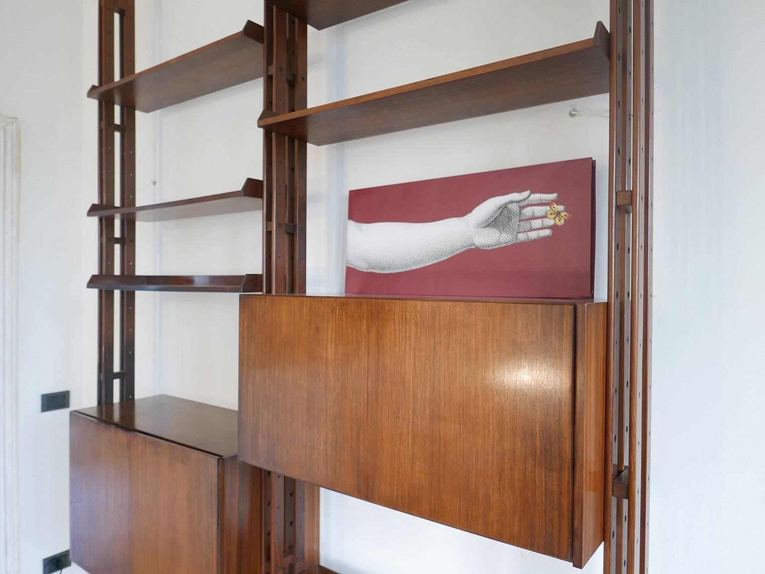 Franco Albini  LB7   Bookcase for Poggi, 1957.
Signed under the feet. 
Rosewood shelves and cabinets,
tree mahogany upright supports, six shelves and two cabinet. Adjustable black lacquered  aluminum braces at top and bottom .
Very good original