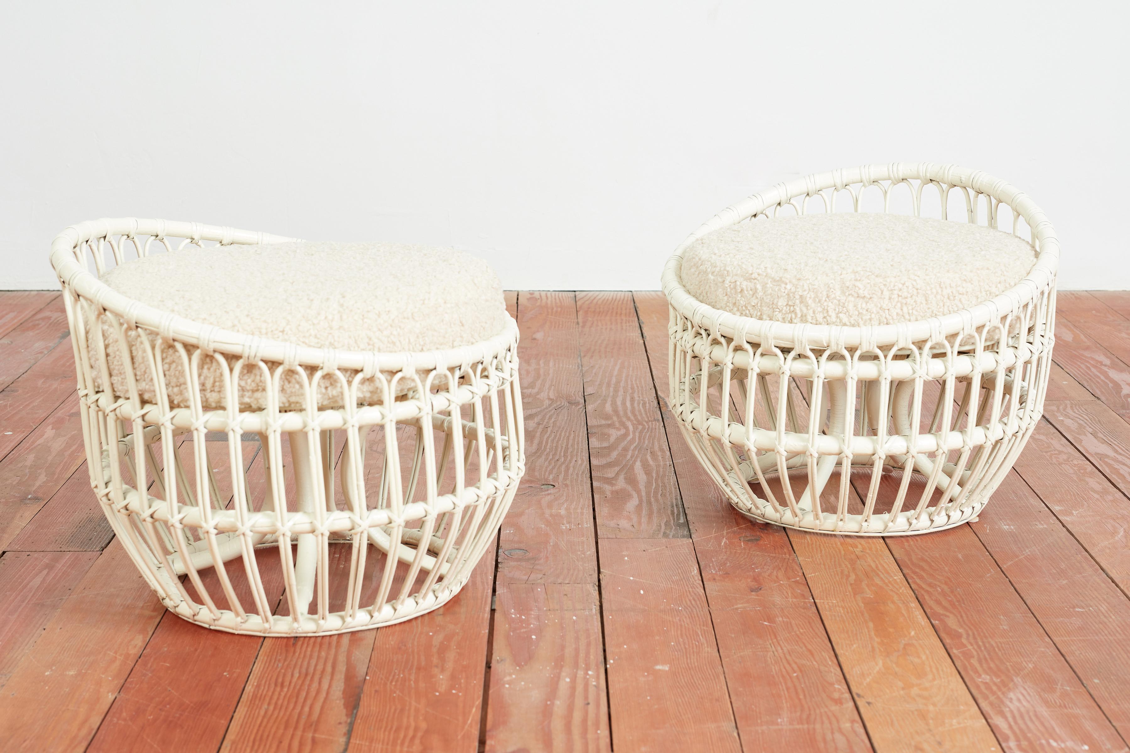 Unique shaped rattan ottoman/stools by Franco Albini
Italy, 1950s
Circular shaped with curved rattan - newly lacquered white with new creamy boucle upholstered seat cushions 
Sold as a pair 