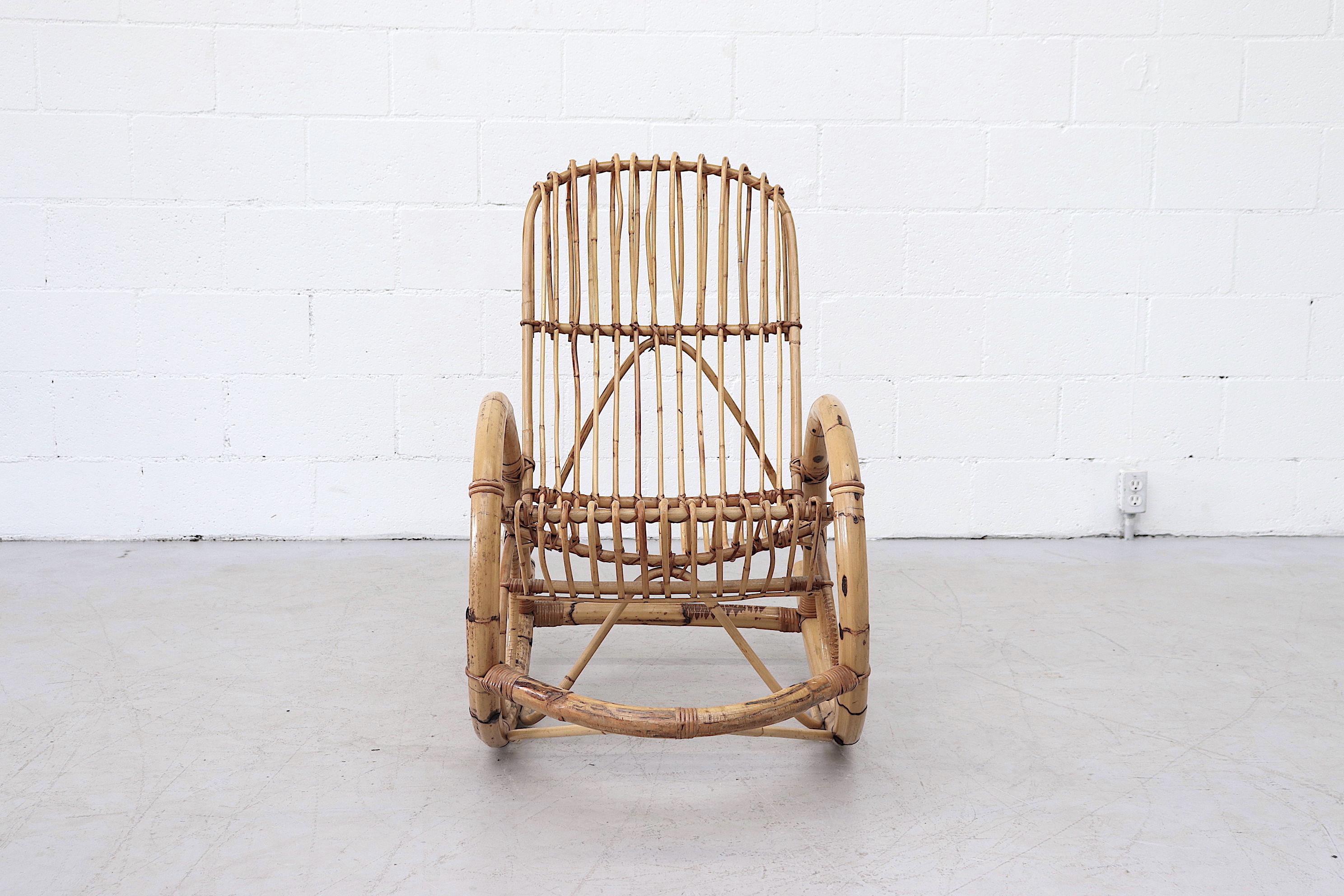 Great Franco Albini style high back bamboo rocking chair in good original condition. Beautiful rocker with moderate wear and minimal bamboo loss. Similar chairs available listed separately.