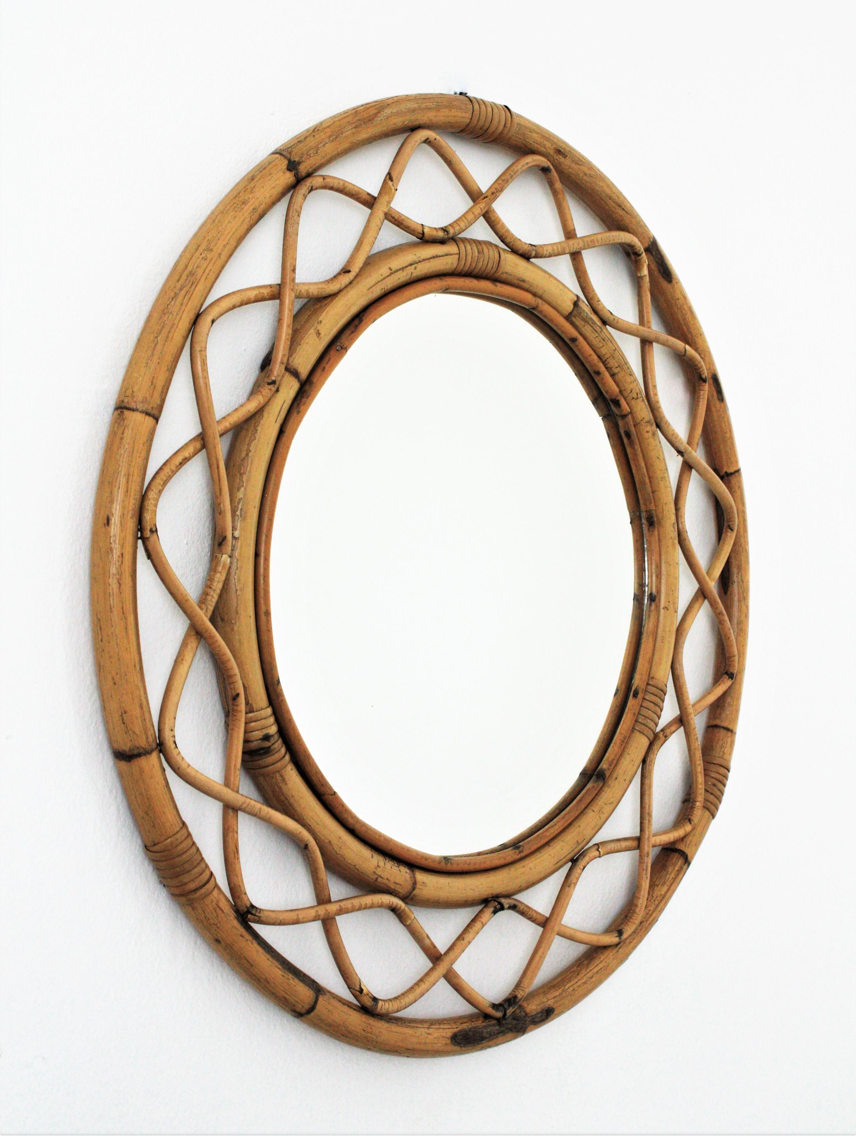 Beautiful bamboo and rattan circular mirror in the style of Franco Albini, France, 1960s.
This wall mirror features two concentric bamboo frames with an intrincate undulated rattan pattern between them.
Place it in a country house, beach house