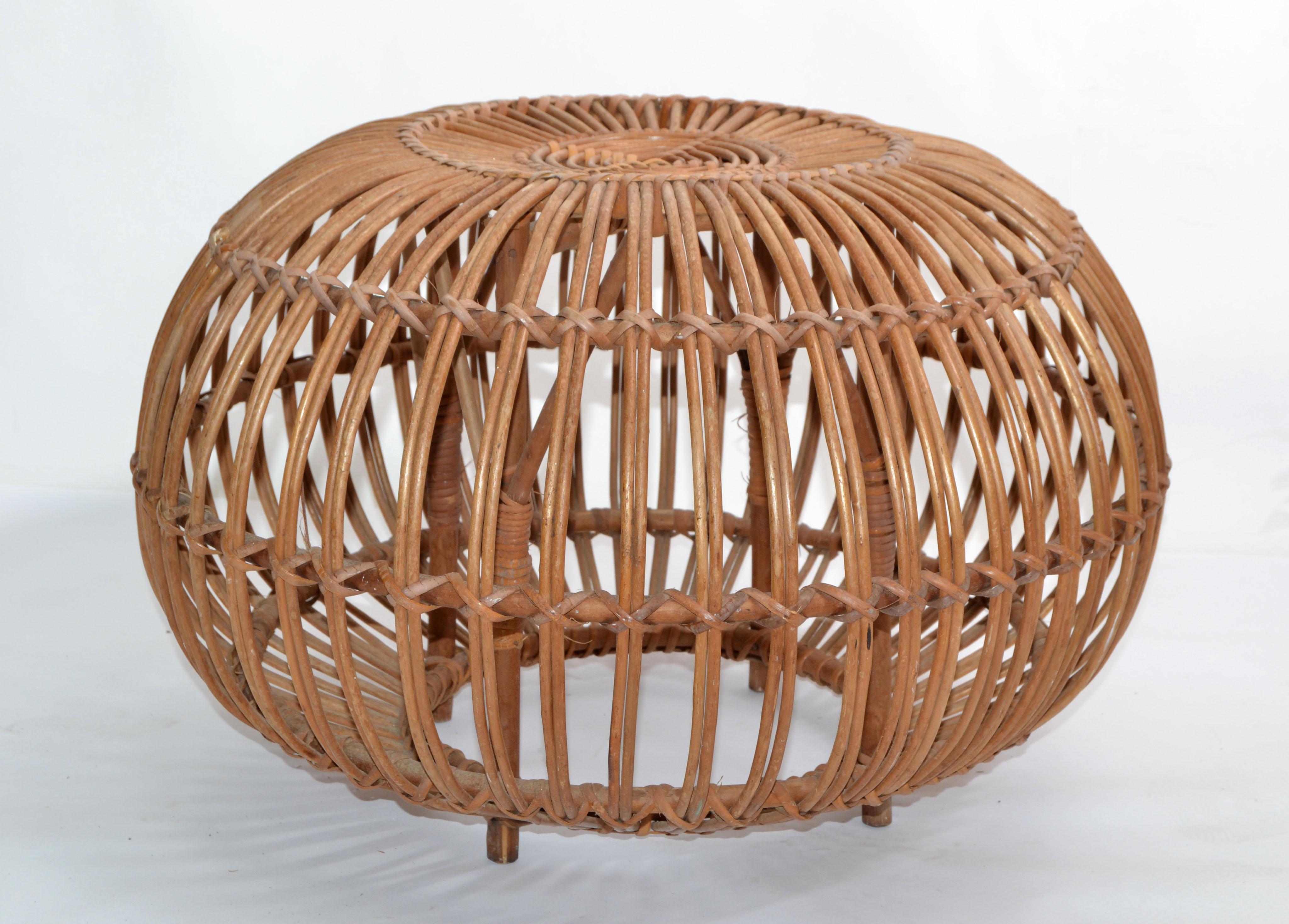 1960s vintage style of Franco Albini & Franca Helg round handwoven rattan, wicker ottoman, pouf, footstool or side table.
Exemplary construction, woven ties are firmly linked.
An iconic design Classic made in Italy.
The Wicker Armchair for the