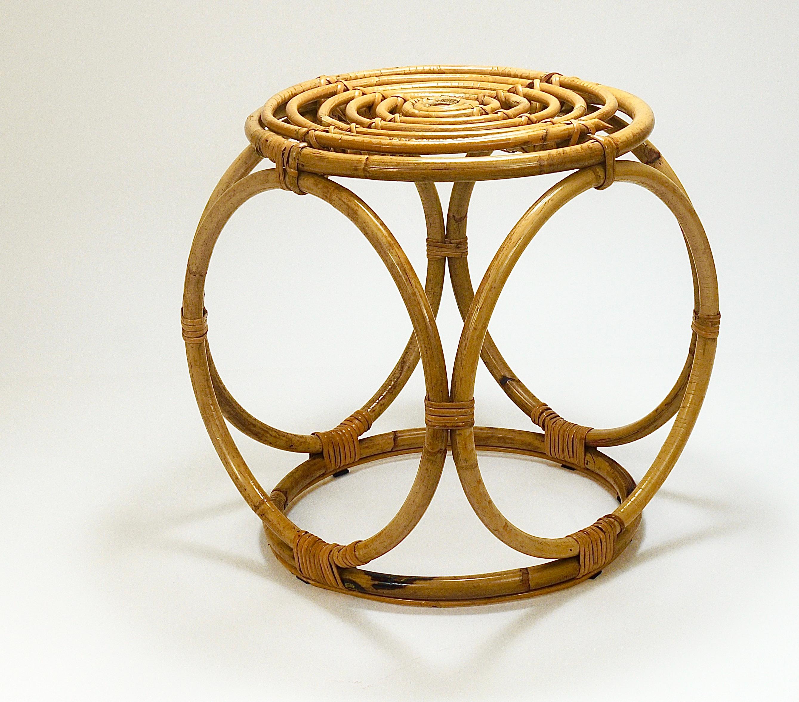 A chic French Riviera style midcentury modern cubic bamboo rattan stool or side table from the 1950s/1960s. Traditionally handmade of bamboo and rattan / cane / wicker. A decorative but versatile piece of furniture, which can be also used as an end