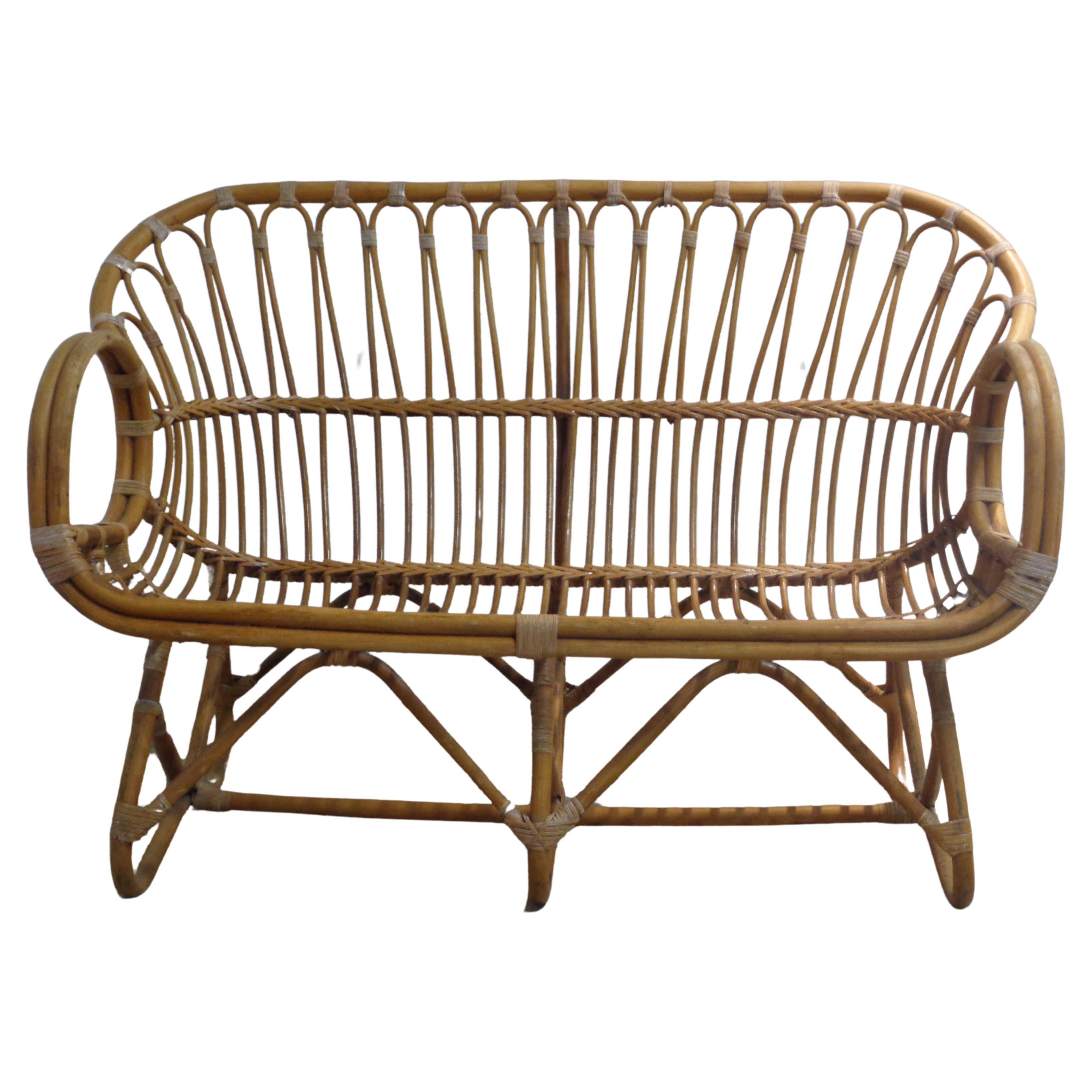 Woven bent natural rattan and cane wrapped settee with a beautifully designed sculptural form. In the style of Franco Albini. Circa 1960-1970. Very good all original condition. Look at all pictures and read condition report in comment section ****