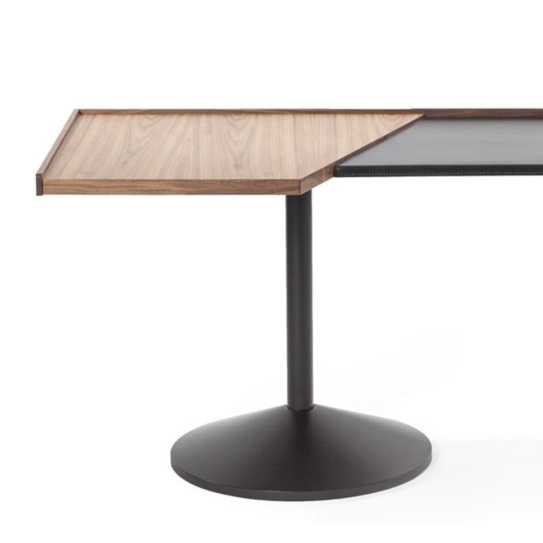 Table designed by Franco Albini in 1954.
Manufactured by Cassina in Italy.

This table/writing desk, designed by Franco Albini consists of two trapezoidal planes, one smaller than the other, on a single steel support. This balancing act is