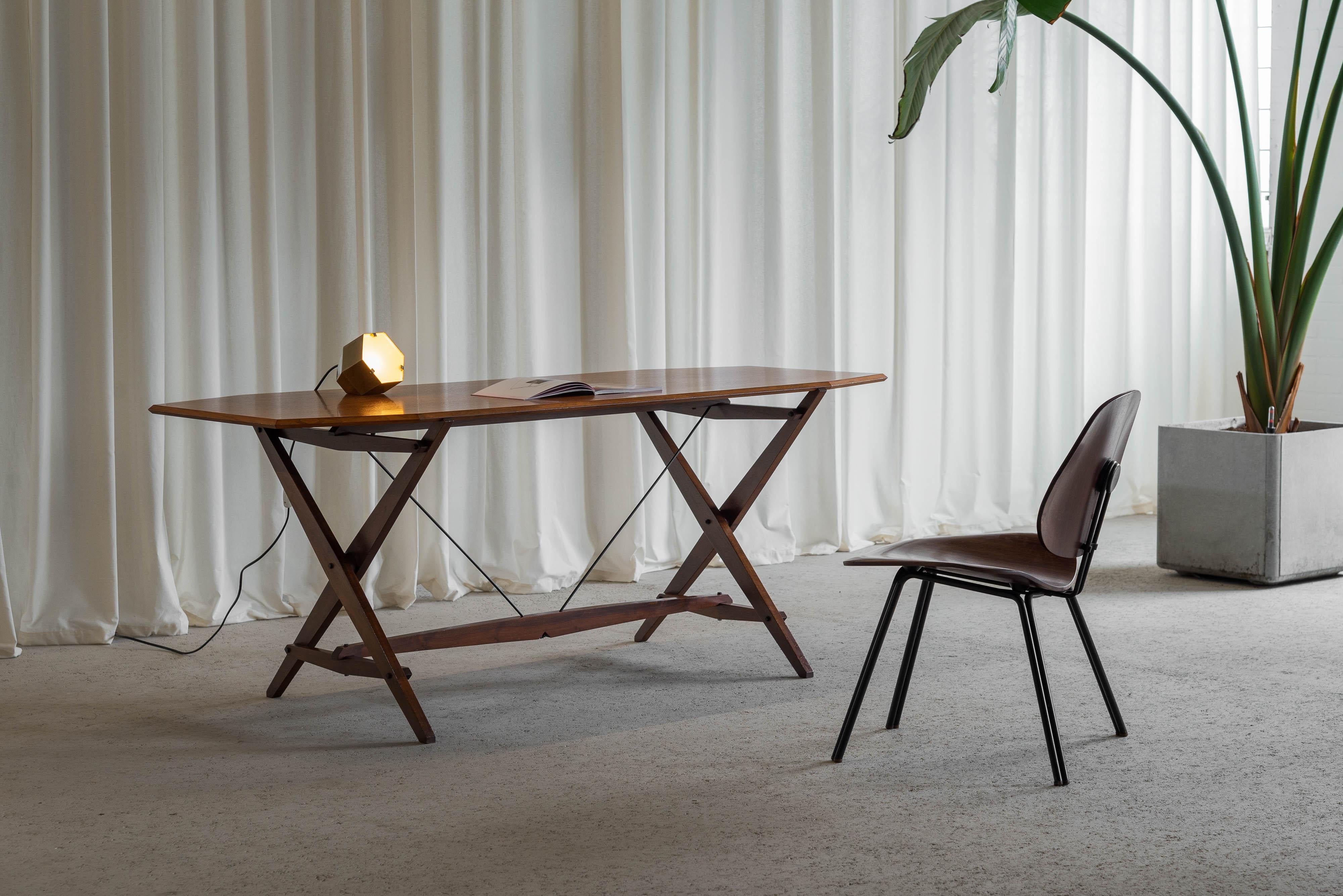 Iconic and early example of the TL2 'Cavalletto' table designed by Franco Albini and manufactured by Poggi in Italy around 1950. The table has an amazing dynamic and archtectural shape with symmetrical angles and a mix of materials making it one of