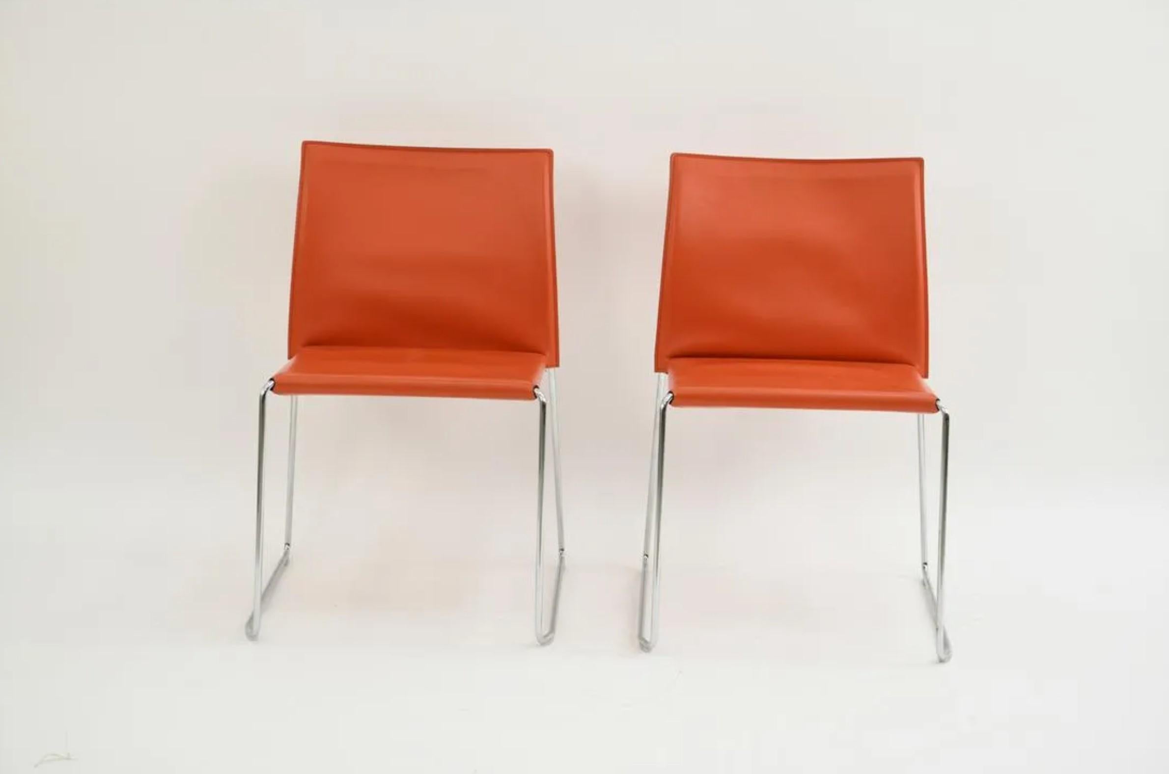 Model: Bizzy chair. A set of ten chairs by Italian designer Franco Bizzozero for Enrico Pellizzoni. With sleek and clean lines, this design features a trim chromed sled base, and finely tailored and stitched vibrant orange leather. 

Available in