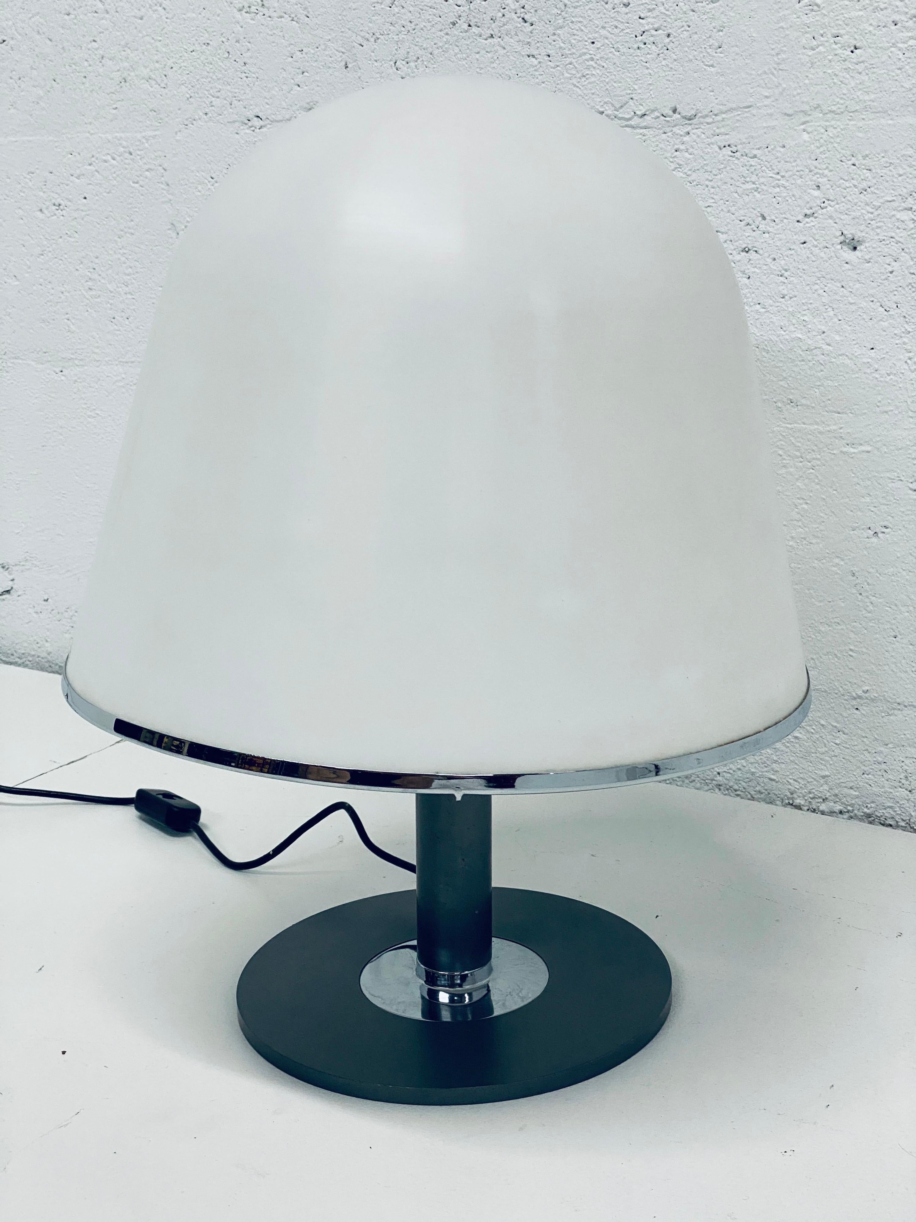 Mid-century Kuala desk or table lamp made of a matte white molded plastic dome shade on a gunmetal and polished steel base designed by Franco Bresciani for iGuzzini. Wired for USA.