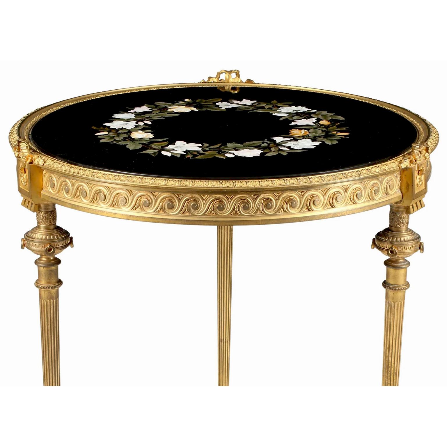 A Very fine Franco-Italian 19th century neoclassical Revival style gilt-bronze and Pietra Dura (or Pietra-Dure) occasional side-table Gueridon. The circular gilt-bronze frame raised on three fluted legs conjoined at the base, topped with Greco-Roman