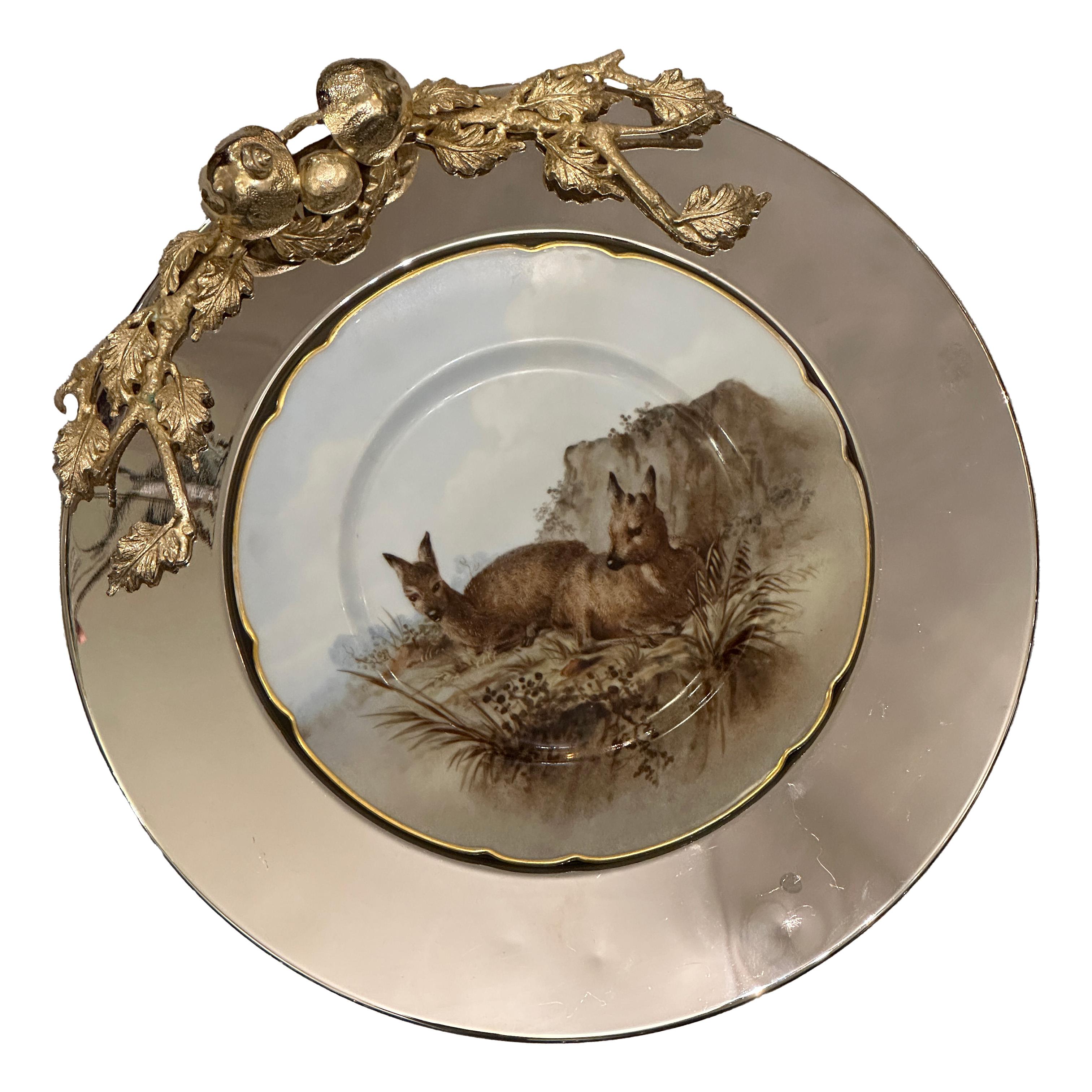 Impresionante plato de Franco Lapini, fabricado en acero plateado. Cada pieza presenta un elegante diseño en alto relieve cromado y dorado que representa un caracol, tres setas y dos ramas de roble, finamente esculpidas para crear un refinado motivo