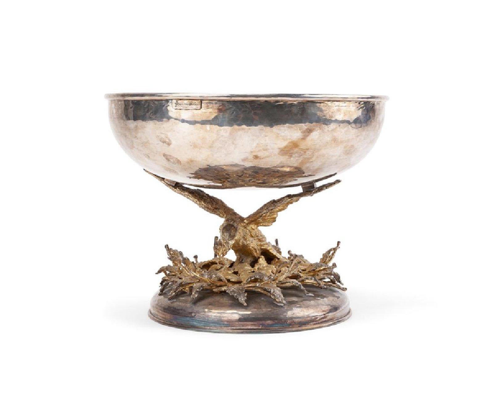 Third quarter of the 20th century
Signed to rim: Franco Lapini / Made in Italy
The silver-plated hammered bowl resting on a gold plated bird's outstretched wings over a nest of leaves on an domed base
Measures: 10.75
