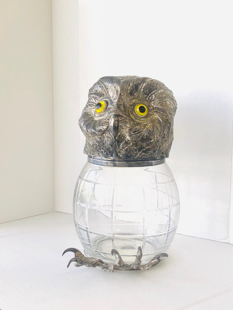 A whimsical cookie jar or container by Franco Lampini. The head of the owl is silver plated with glass eyes, the body is cut crystal, the feet are also silver plate. The head is hinged to the body.