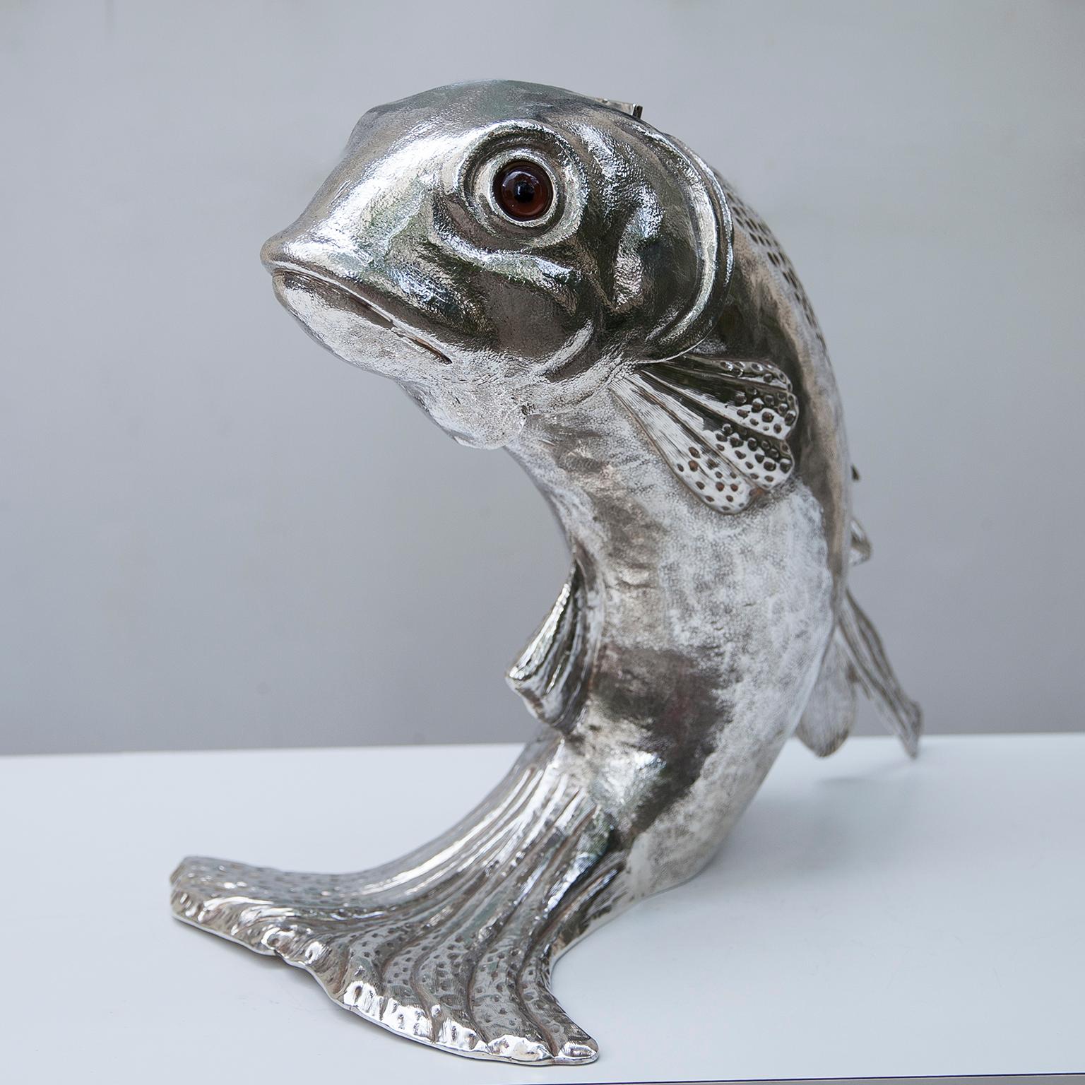 Franco Lapinis exquisite dolphin ice bucket and wine cooler is made entirely of metal plated in silver and its surface is lightly textured to give it an organic feel. When you open the head, there is removable plastic inlay. Either alone or combined