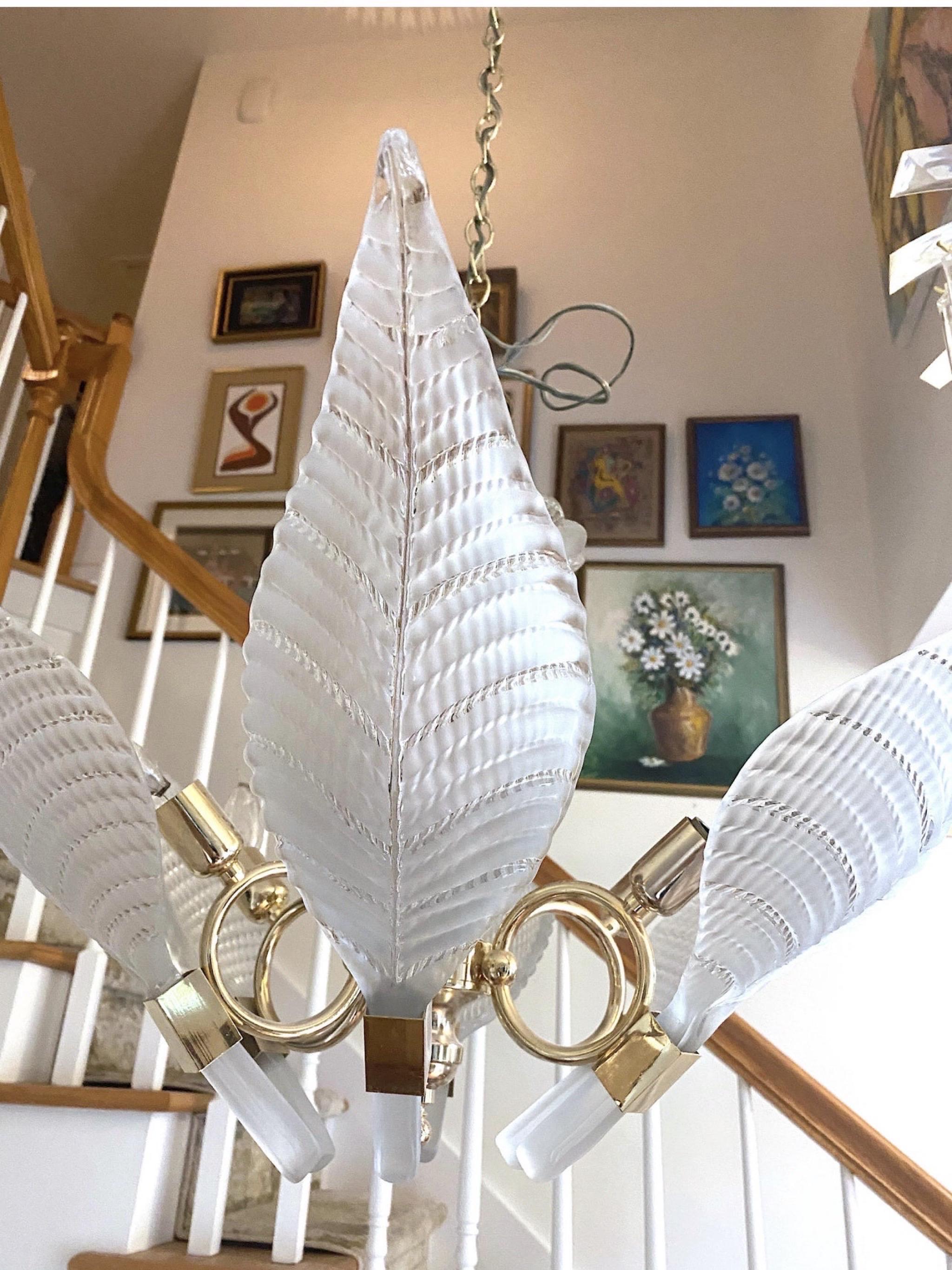 Sculptural glass palm leaf chandelier by Murano features brass frame and 6 lights. Clear and opaque glass frawns measure 18