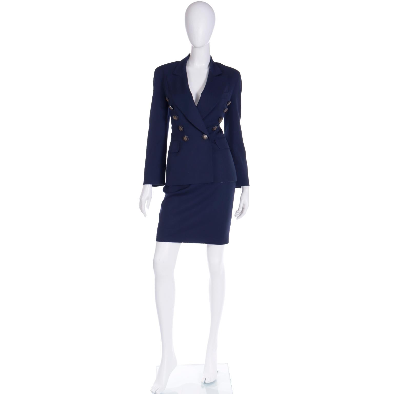 This vintage early 1990's Franco Moschino Couture! navy blue skirt suit includes a jacket and a pencil skirt. We love the details in this suit, especially the jacket! The fabric is a medium weight opaque 100% rayon. We especially love the buttons on