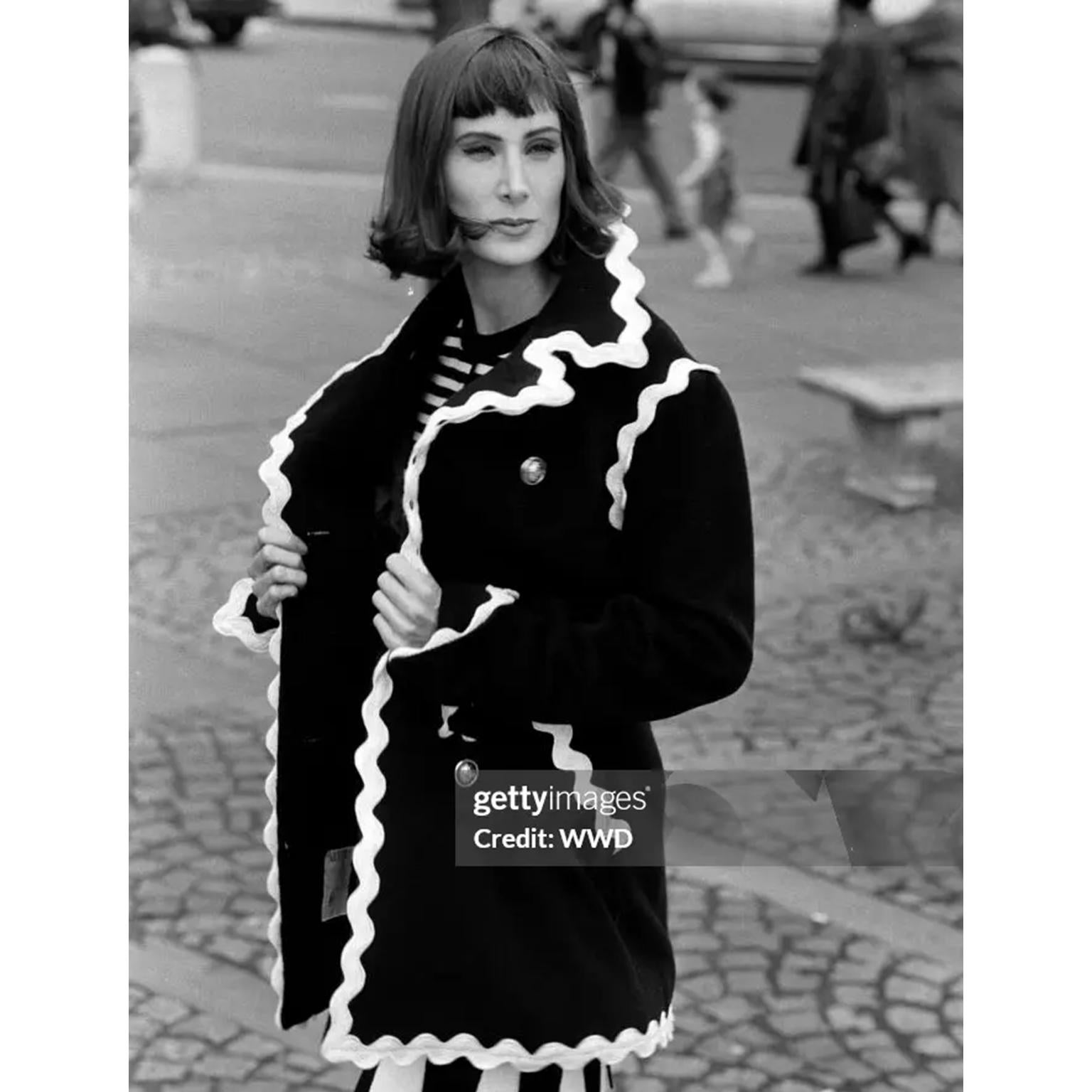 This Fall 1991 Franco Moschino vintage black wool cropped jacket is a great example of Moschino's ability to take a serious piece and make it playful and more wearable. This heavier weight double breasted jacket features cream ric rac trim and gold