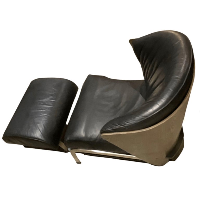 Franco Raggi for Cappellini 
Lounge chair & ottoman
Black leather with wood back
Matte metal framing & lLegs
Produced 1980's - 1990's
In overall very good condition
Minor wear on the base sides of the wood back.
Minor wear in the seam of the