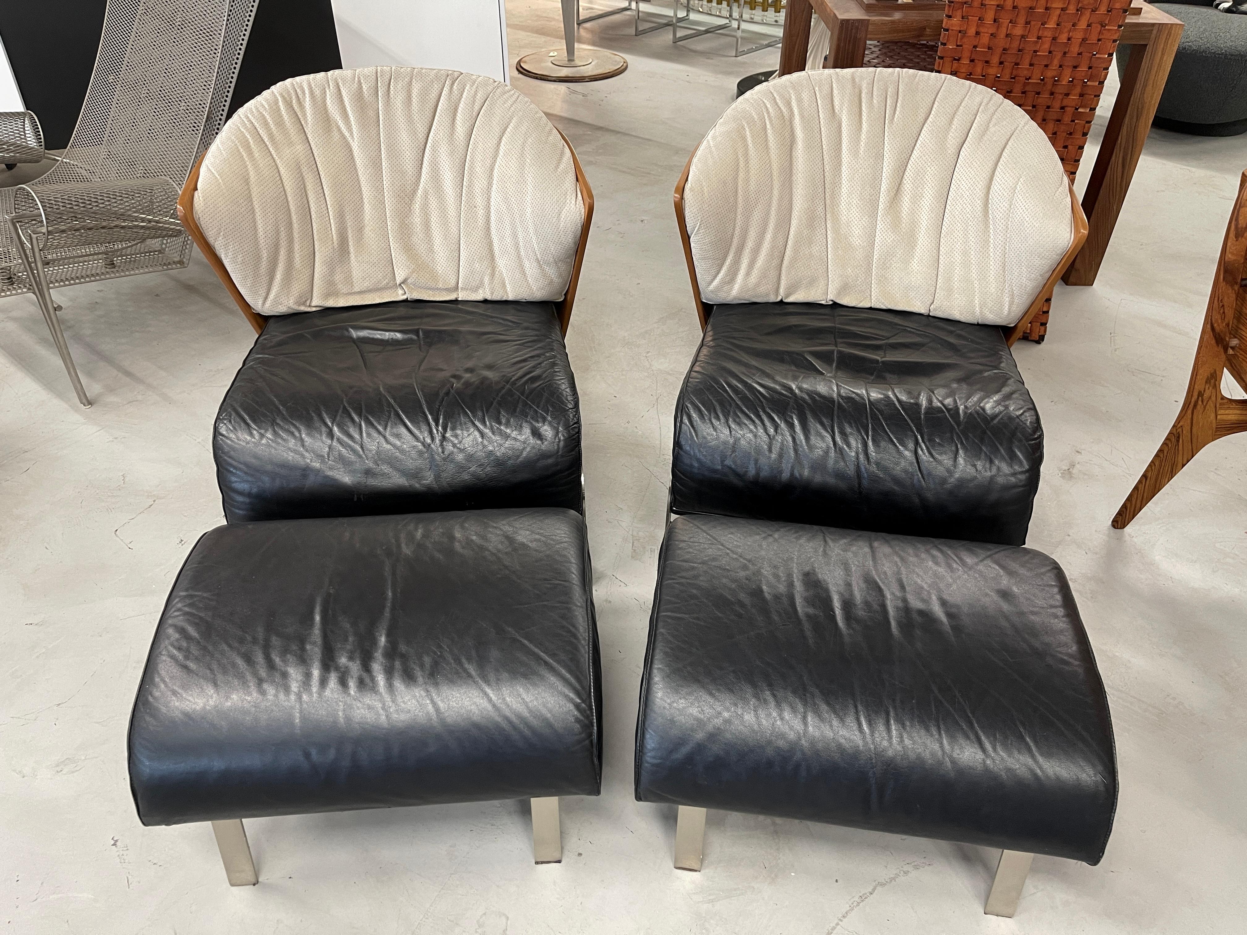 Wonderful pair of Elba chairs and ottoman by Franco Raggi for Cappellini. These were first designed in 1983 and produced in the 1980s through the late 1990's. This production is from the 1990's when they were purchased. Beautiful elegant lines with