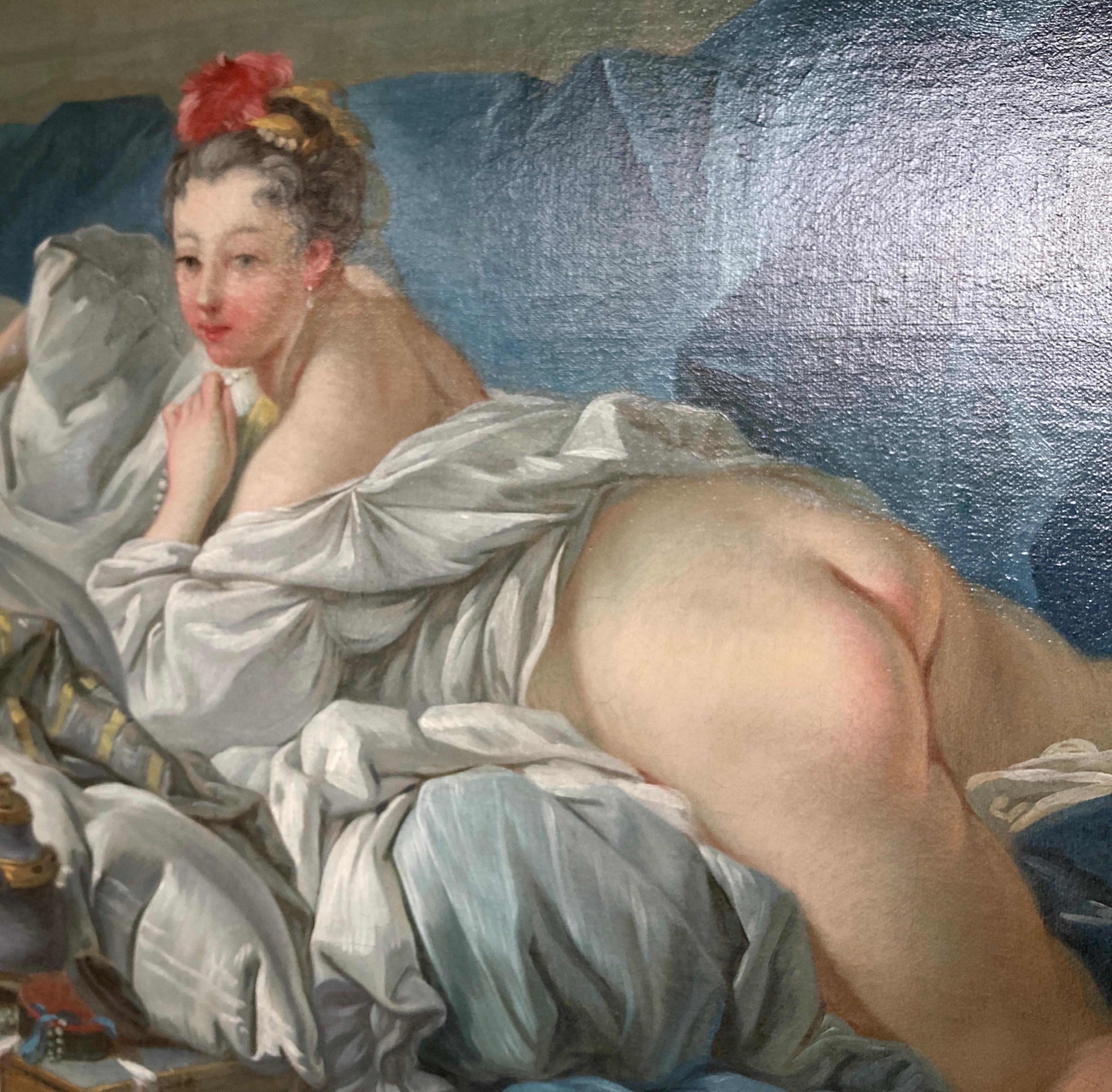 A voluptuous woman lies prone on a divan, bearing her backside and turning her head flirtatiously to the viewer, though averting her eyes slightly, as if to maintain a coy demeanor. Surrounded by lush fabrics of deep blues, the creamy tones of her