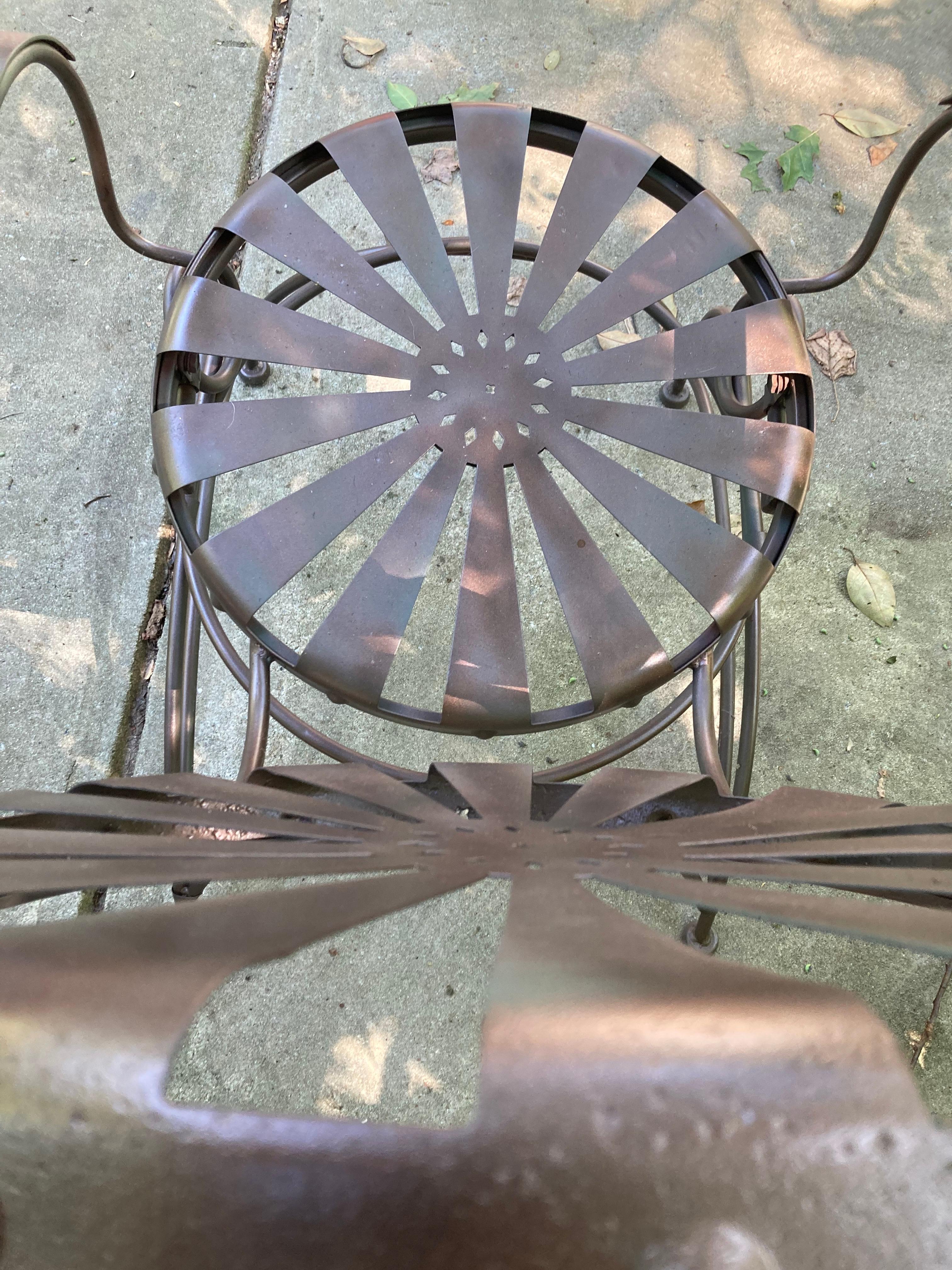perfect for the mediterranean garden enthusiast, two rockers, sandblasted then primed in black, first coat in olive green then finished with a shimmering dark copper. metal has some pitting as photographed. these lean back and are as comfortable as