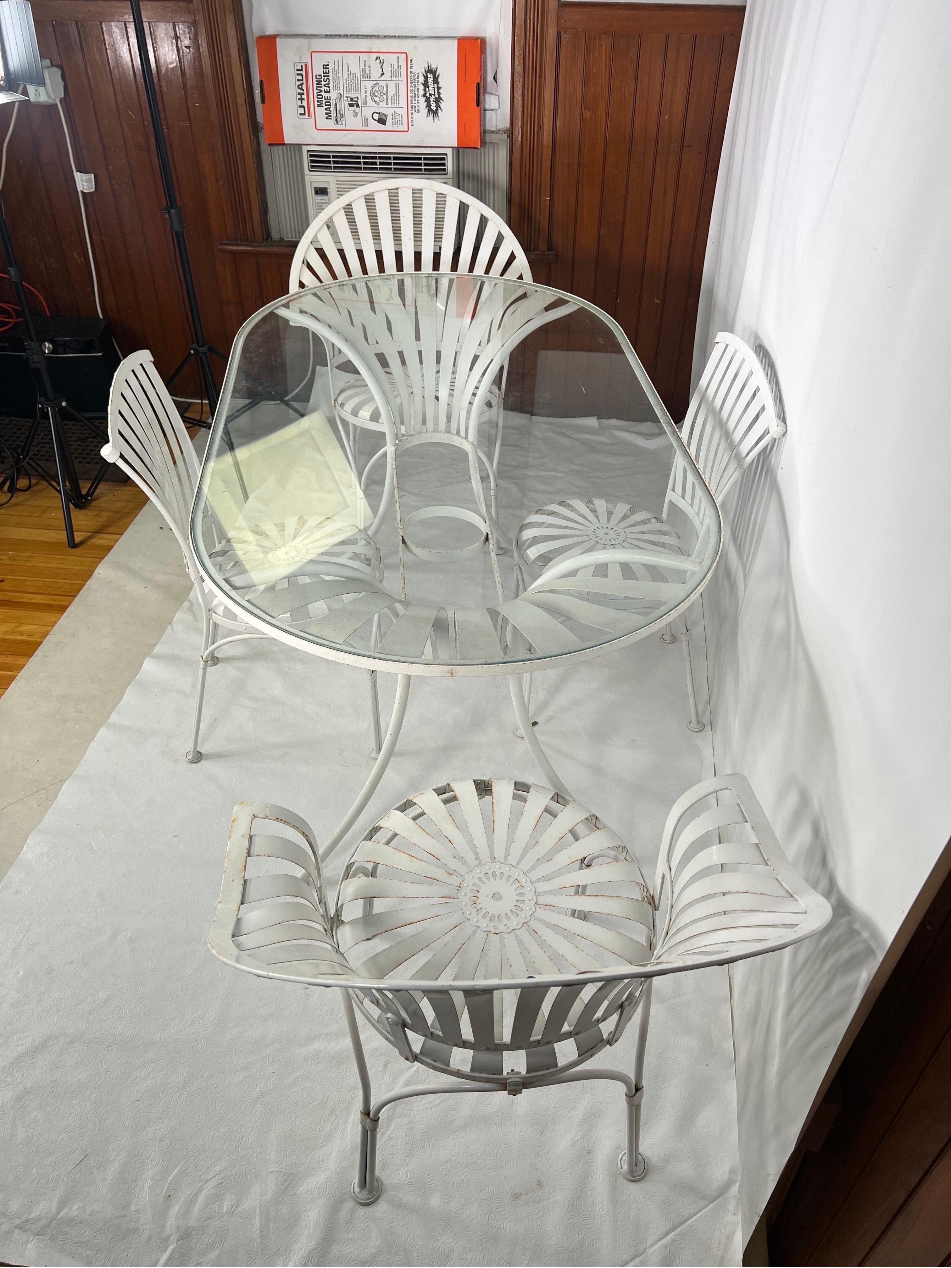 Francois Carre Patio Table and Chairs - 5 Piece Set

French iron garden set by Francois Carre, with glass top table, two spring arm chairs , and two armless spring chairs.

The table measure 60.5 W 33 3/4th D 29 3/4th H
Arm chairs measure 26.75 W 18