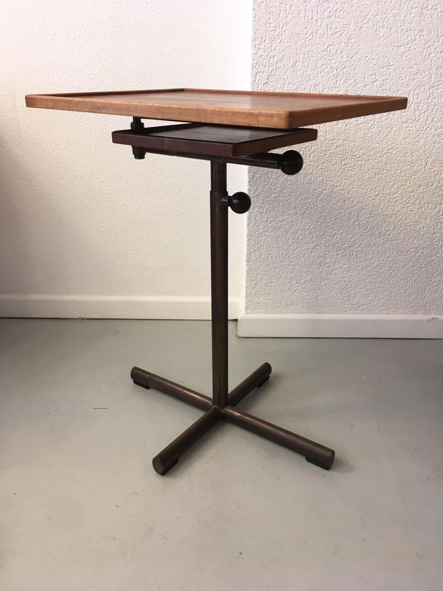 Vintage adjustable walnut and steel table by François Caruelle produced by Embru-Werke, Switzerland, circa 1942

Measures: Large tabletop width 50 cm x depth 40 cm
Small tabletop width 25 cm x depth 25 cm
Height from 65 to 100 cm

The large