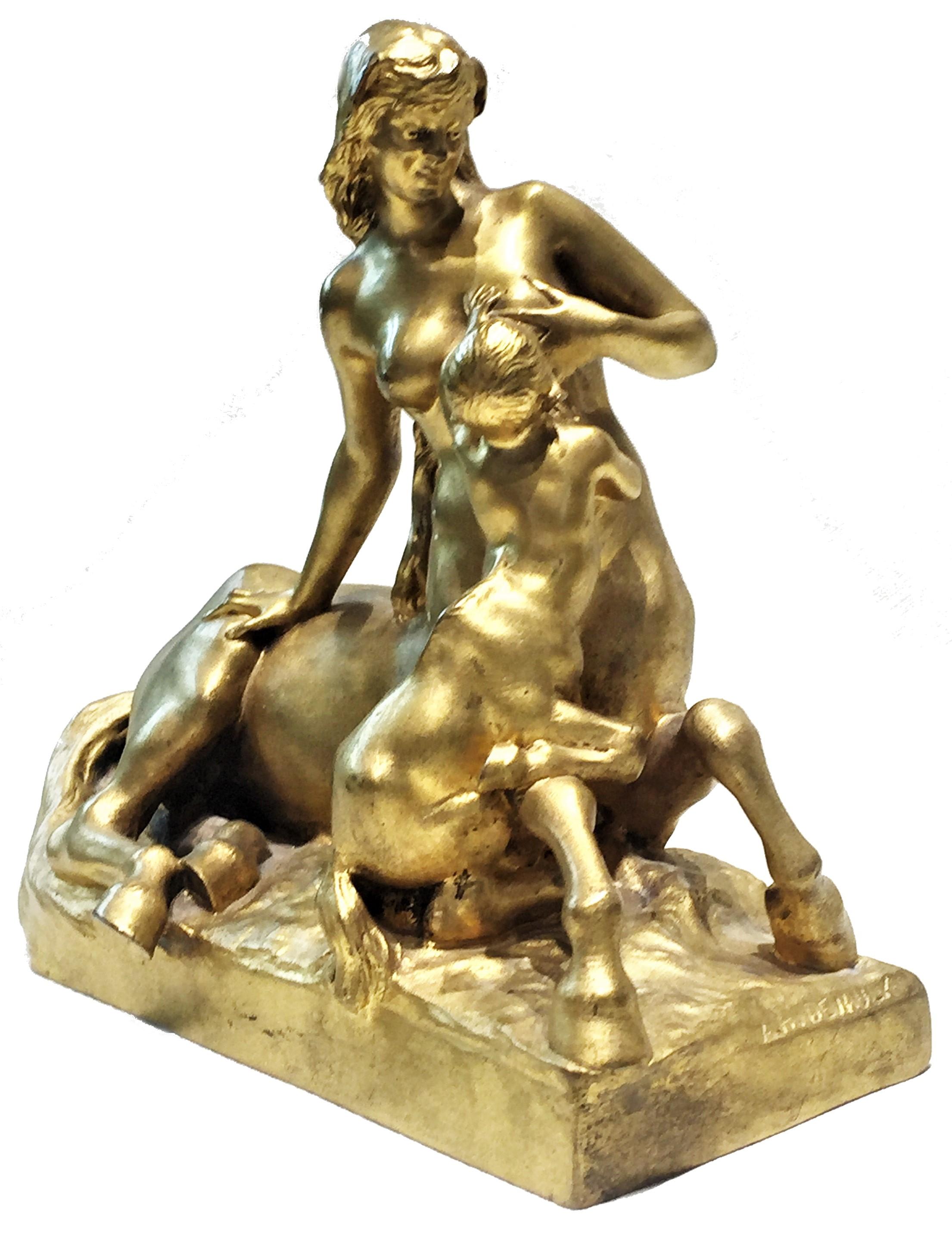 Signed “A.H. Devaulx”, and marked “Susse Fes Ed.20”
Dimensions: Height 6-7/8”, width 7-7/8”, depth 4-1/4”

This wonderfully unusual desktop sculpture of gilded bronze, depicting a beautiful female-centaur breastfeeding her cub is made in a classic