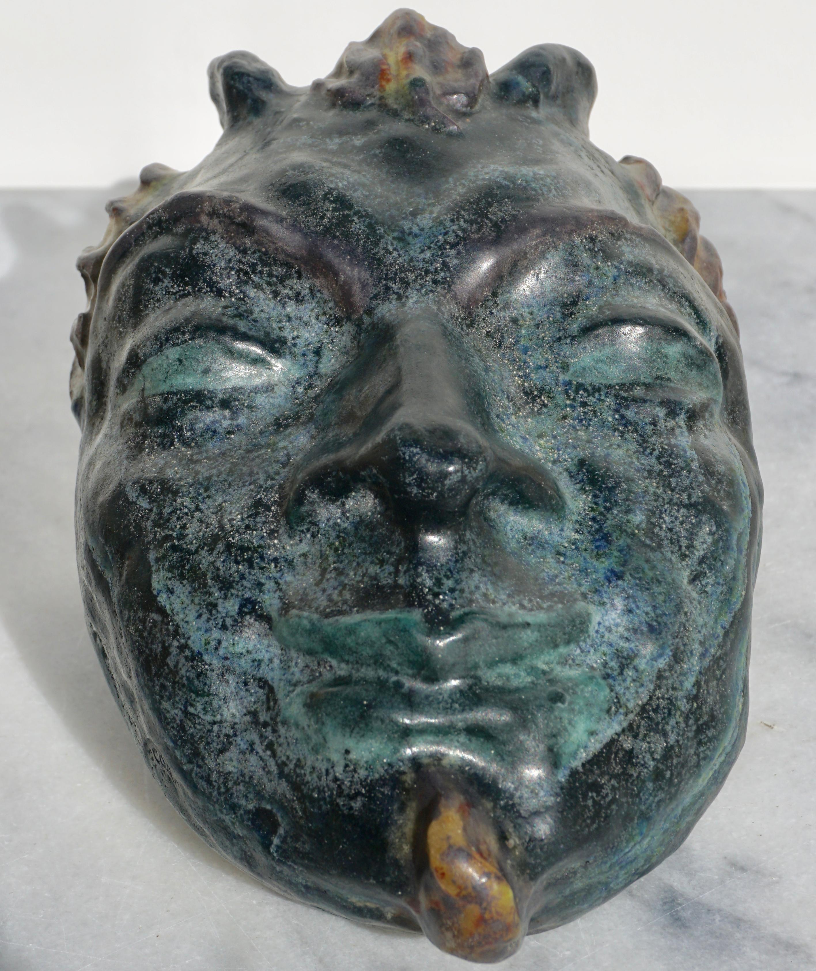 A rare and large pate de verre molded sculpture of the mythological God Pan. Very thick and heavy; this glass piece is primarily bluish green with yellow, reds and orange. The likeness is uncanny with perfectly modeled facial features and traces of
