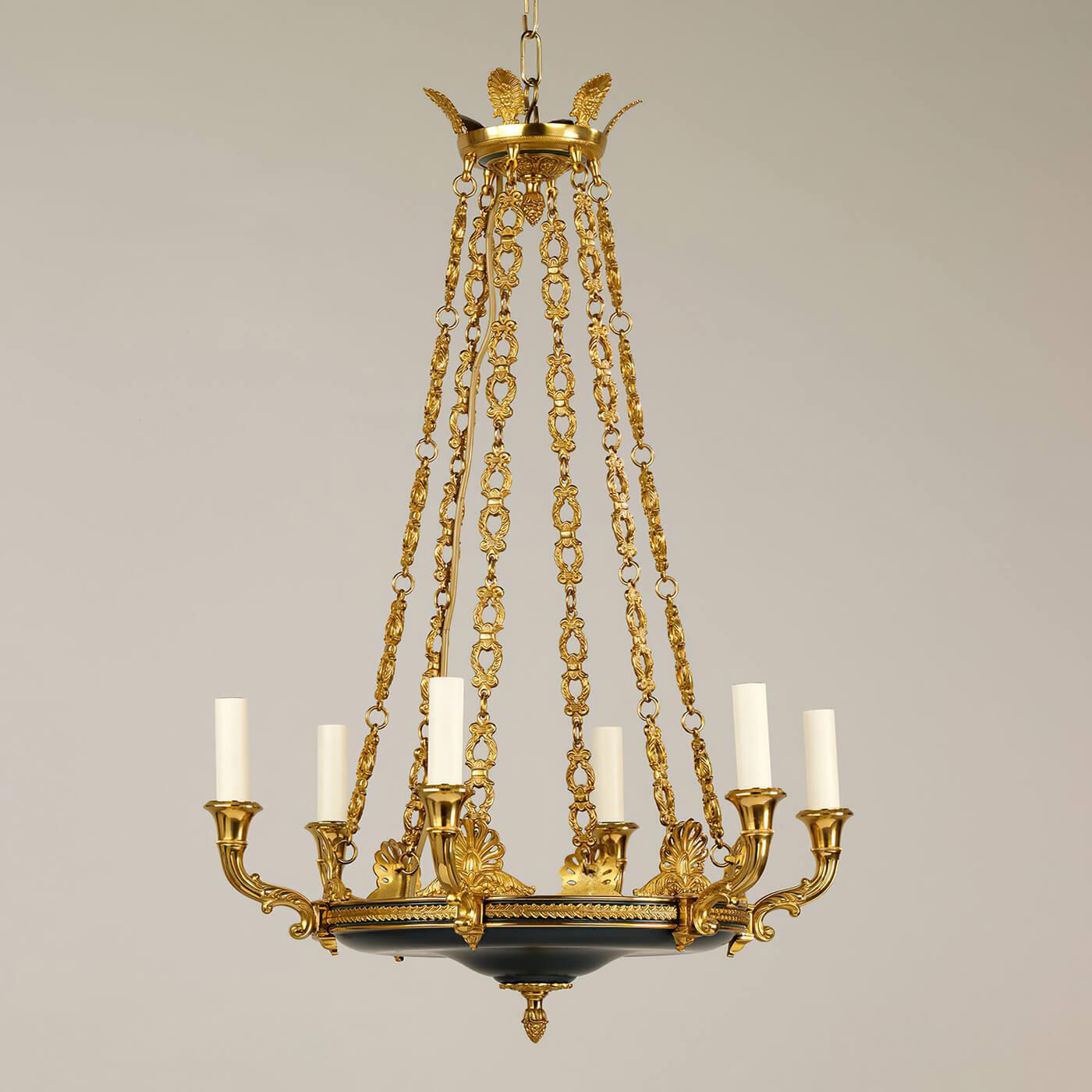 Francois Empire six-light chandelier, the ornate decoration on the arms, and the arrangement of the chains demonstrate exceptional casting in brass. With beautifully cast floral details of acanthus and palmettes, with acorn finials and a black