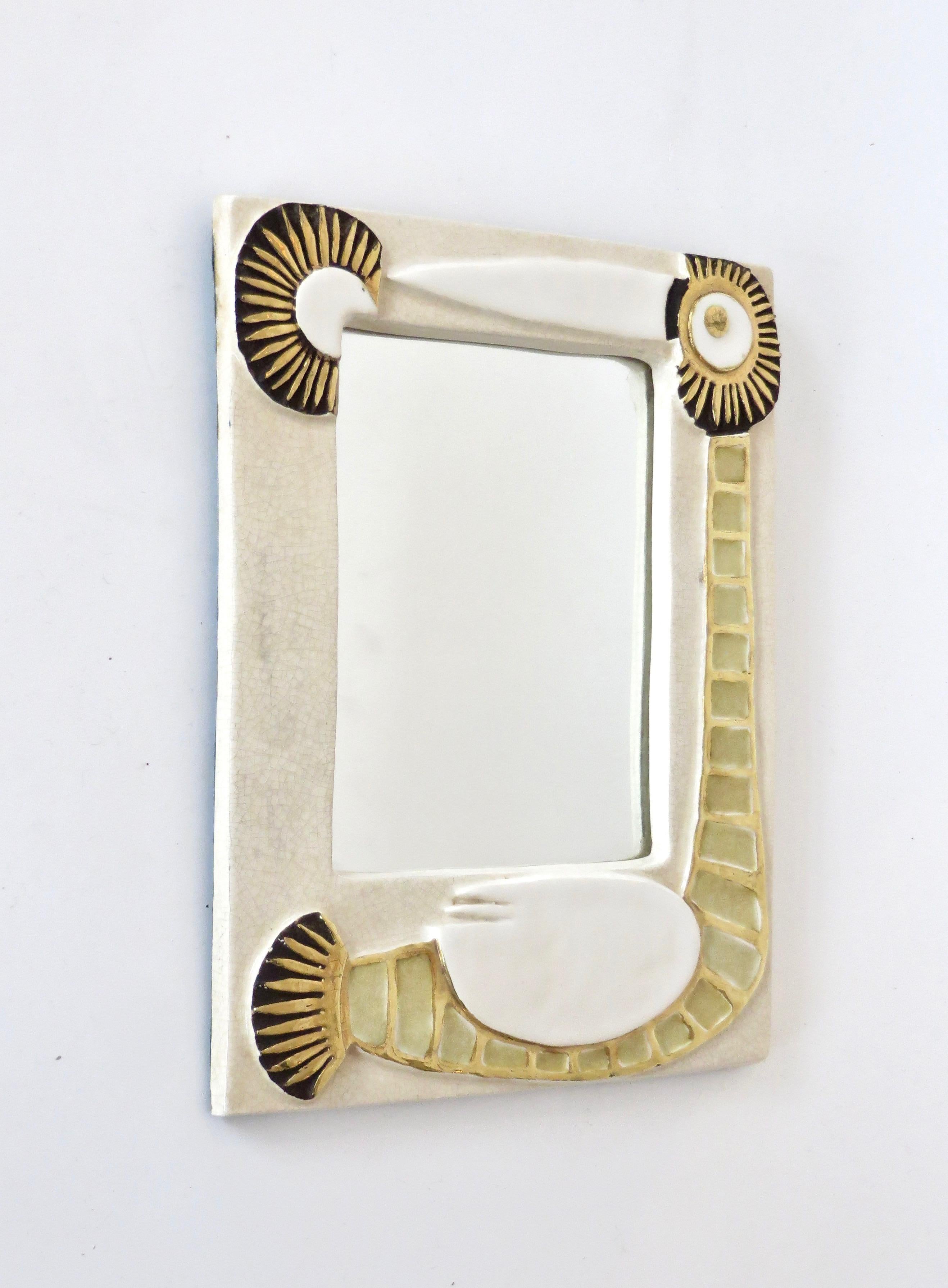 A French ceramic mirror by Mithé Espelt with stylized bird motifs in gold and cream glaze,
France, 1970s. In very good original condition with felt backing.
