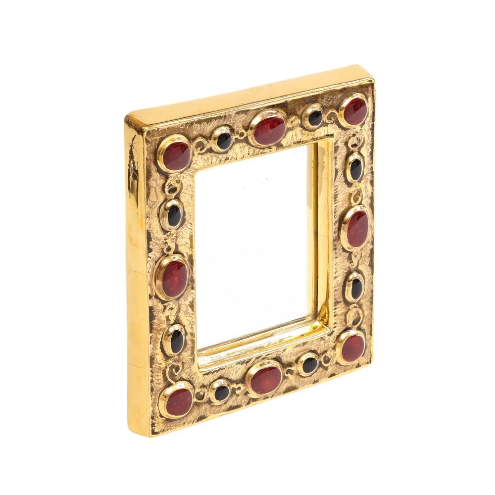 François Lembo mirror, ceramic, gold, red, black, jeweled, signed. Small scale gold glazed mirror decorated with ruby red and black embedded jewels. Signed F. Lembo with incised signature on the back. Embedded wire hook on back for wall hanging.

A