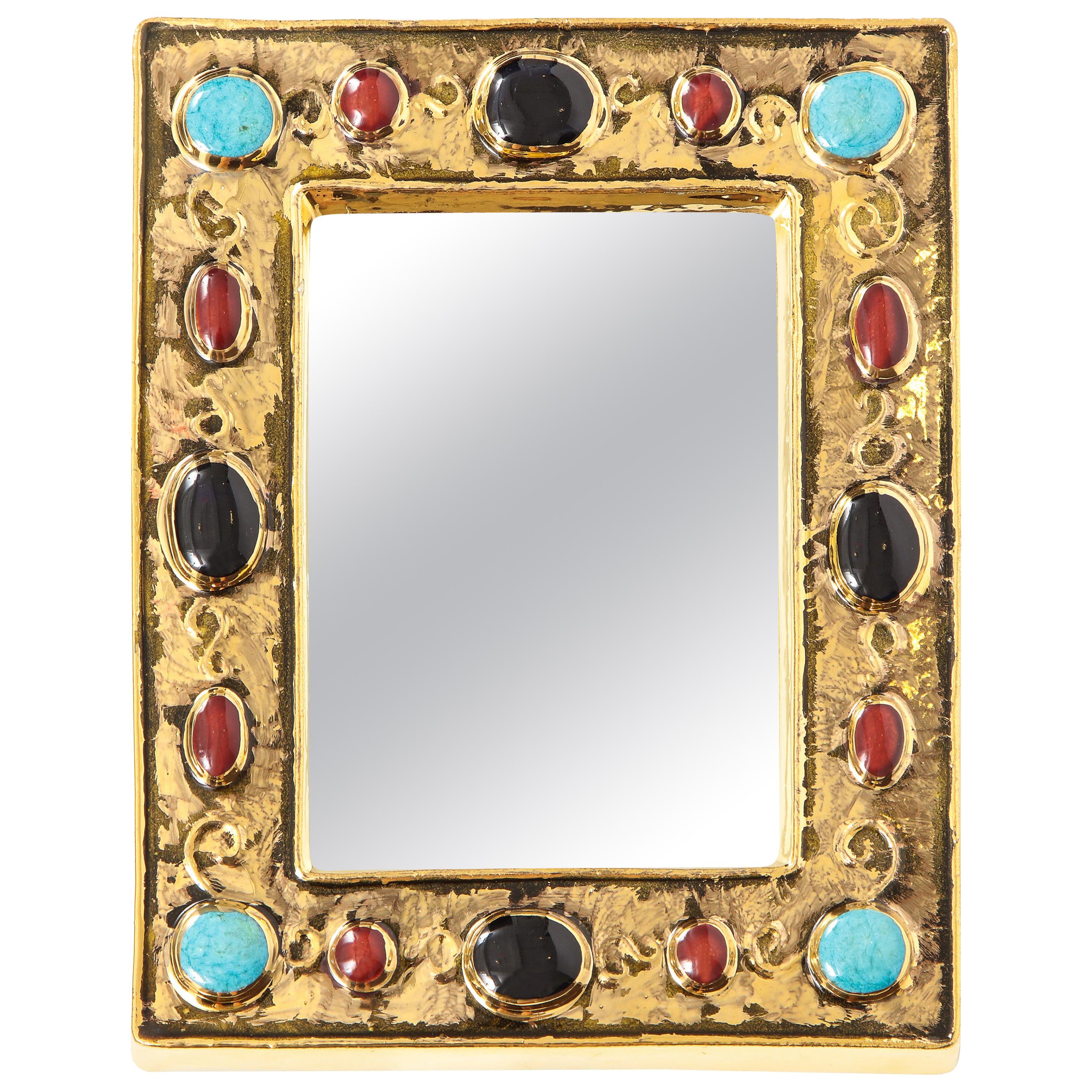 Francois Lembo mirror, ceramic, gold, turquoise, black and red, jeweled, signed. Small scale gold glazed mirror with embedded jewel decoration. Signed: F. Lembo with incised signature on the back.

A native of Vallauris François Lembo started his