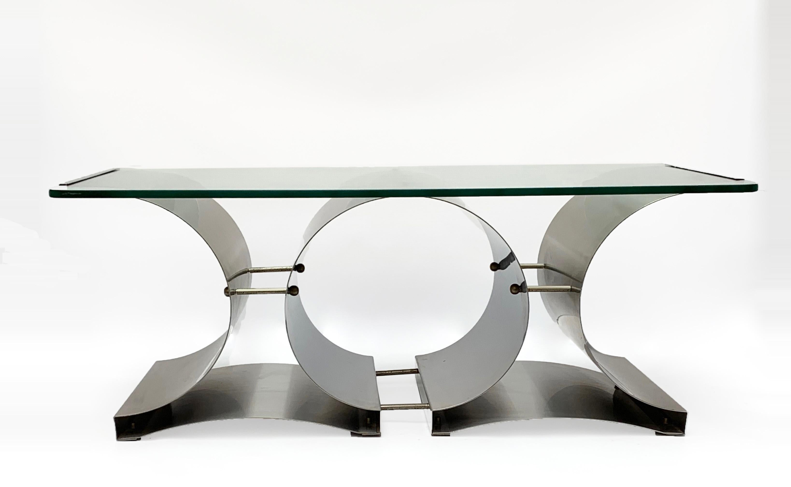 Amazing midcentury brushed stainless steel coffee table with crystal glass top. This wonderful piece was designed by Francois Monnet in France during 1970s.

This high-quality table has a brushed stainless steel base and a crystal glass top that