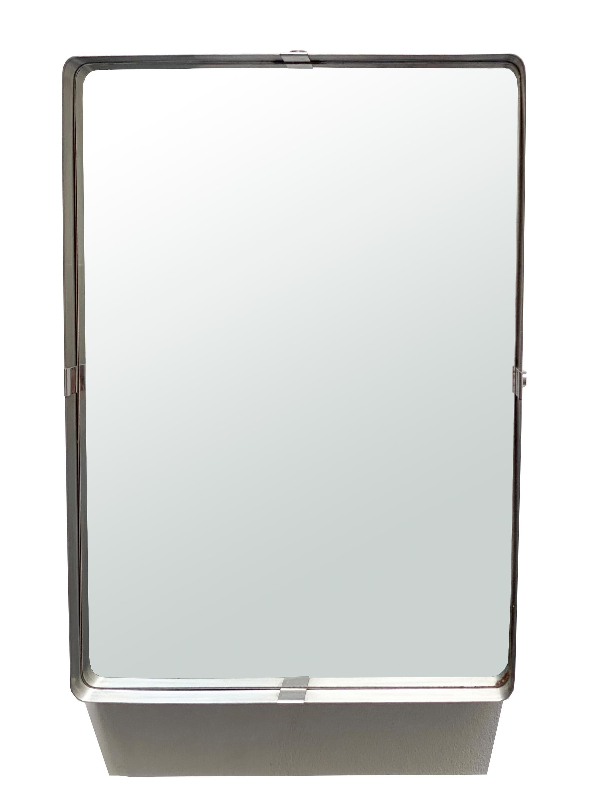 Minimal wall mirror in brushed steel, in the style of Francoise Monnet from 1970. Excellent period condition, patina consistent with use and age.
