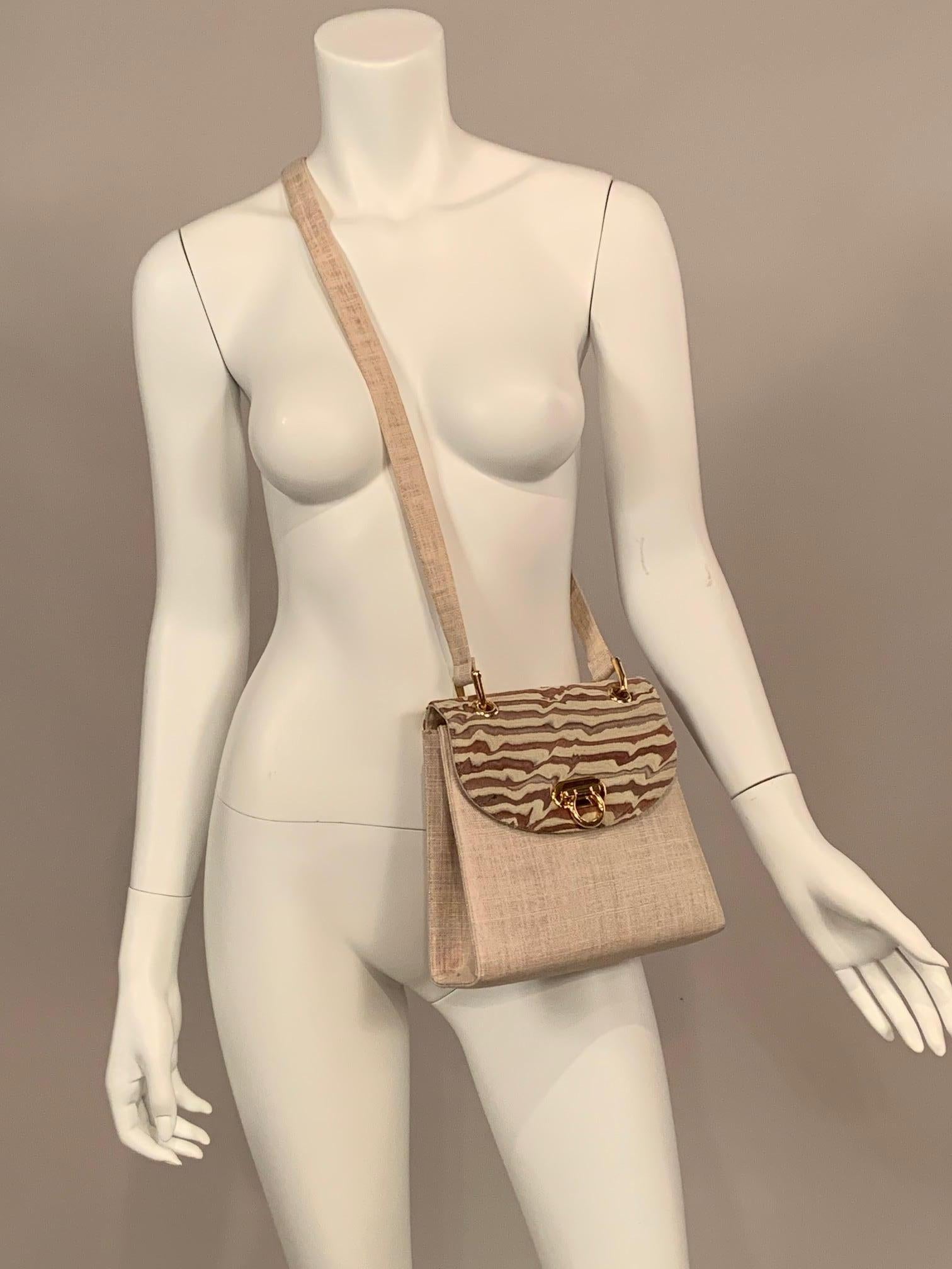 Francois Pinet was founded in Paris in the mid nineteenth century and they are still making beautiful shoes and bags. This crossbody or shoulder bag has a natural linen body and strap with a coordinating patterned linen flap. The hardware is gold