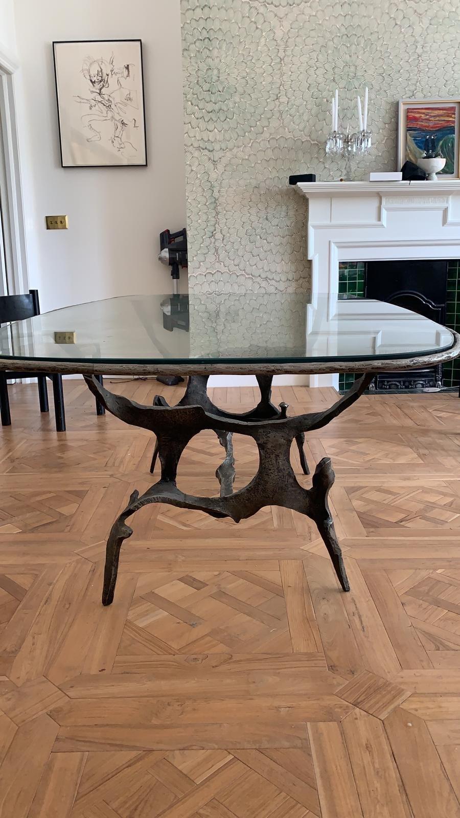 Rare table by Francois Thevenin 
Sculptural bronze base with black patina, original glass top with radial corners. There are small fitted leather pads on feet and arms. Signed . Sculptural base measures

The metal tamer
François Thévenin is an