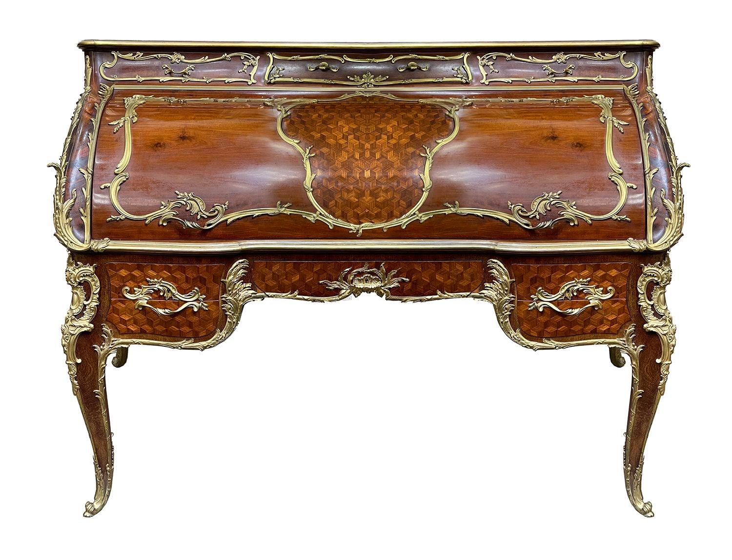 A magnificent, fine quality late 19th Century French Mahogany cylinder bureau, by Francoise Linke. Having a three quarter pierced rococo ormolu gallery to the top, three drawers beneath each with scrolling foliate ormolu mounts and handles. The