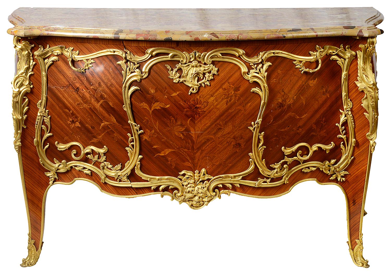 A wonderful quality late 19th century French Louis XVI style marble top bombe shaped commode, having scrolling foliate gilded ormolu mounts, fine marquetry inlaid panels with flowers and leaves, the two doors opening to reveal a shelf