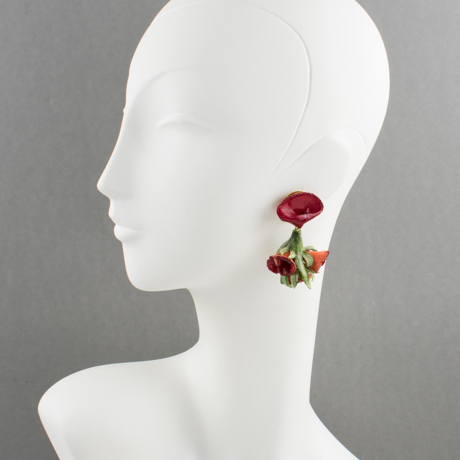 These romantic French Jewelry Designer Francoise Montague Paris clip-on earrings are designed by Cilea. The dangle shape features dimensional flowers with leaves in assorted tones of ruby red and tender green. There is no visible maker's mark since