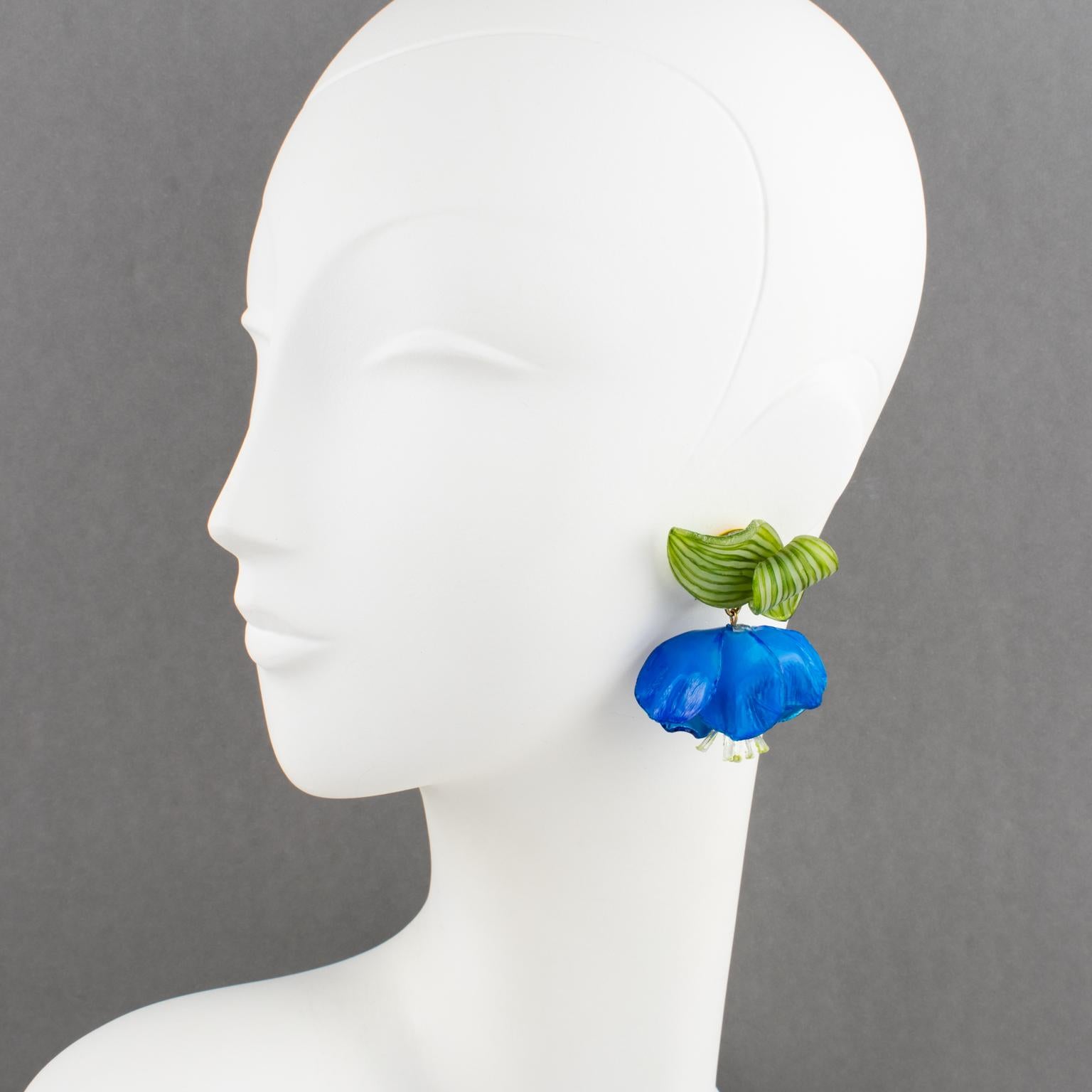 Beautiful resin clip-on earrings designed by Cilea Paris for French jewelry designer Francoise Montague. Dangle shape featuring dimensional blue poppy flowers with green leaves. No visible signature like all the vintage Francoise Montague resin
