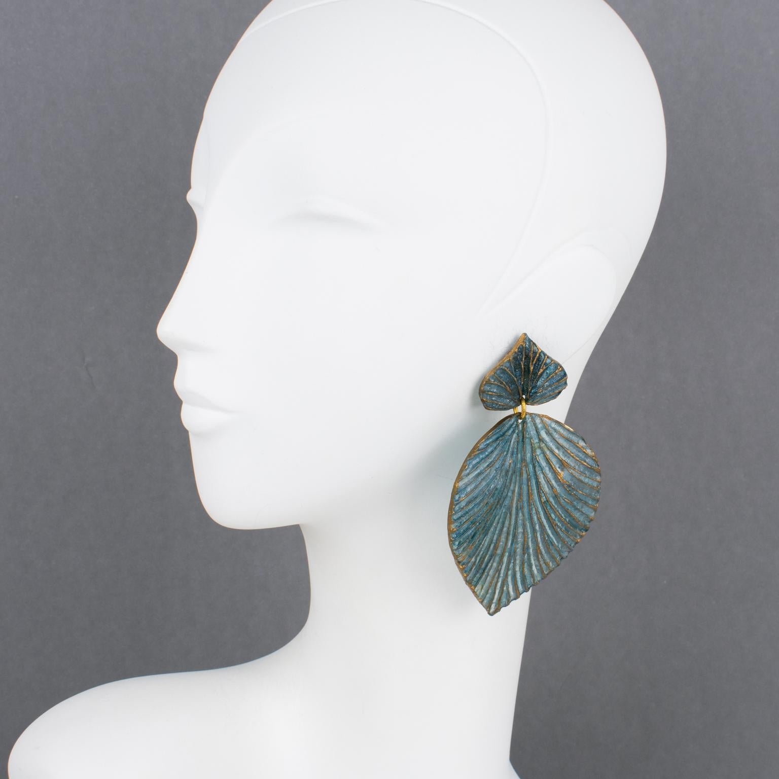 These stunning French designer Francoise Montague resin clip-on earrings were designed and hand-crafted by Cilea, Paris. The oversized dangle shape features a carved, textured, and dimensional stylized leaves design in translucent cerulean blue