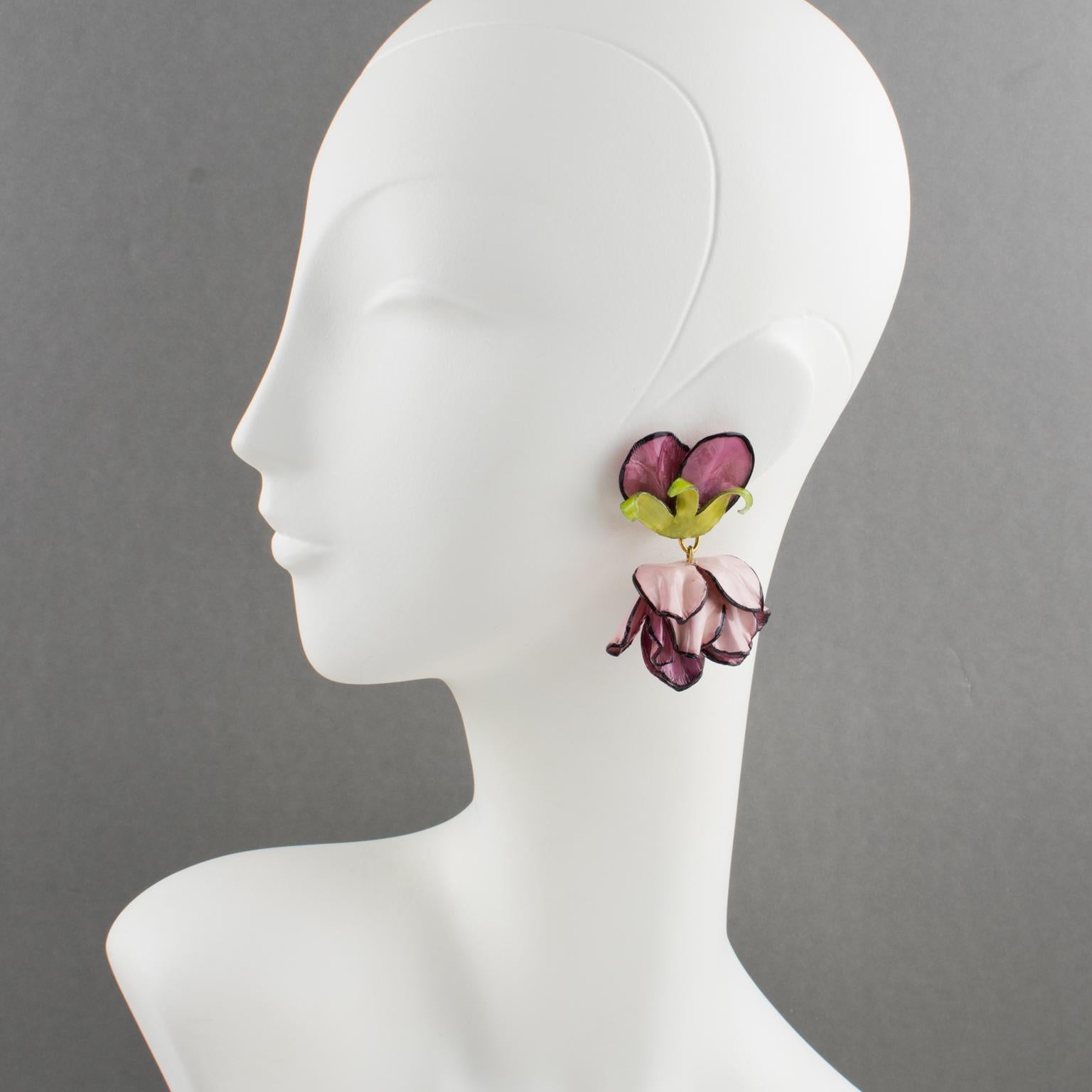 These charming Francoise Montague, Paris dimensional dangling clip-on earrings were designed by Cilea Paris. The floral-inspired hand-made artisanal resin earrings feature poppy flowers with leaves, with textured patterns built together to form a