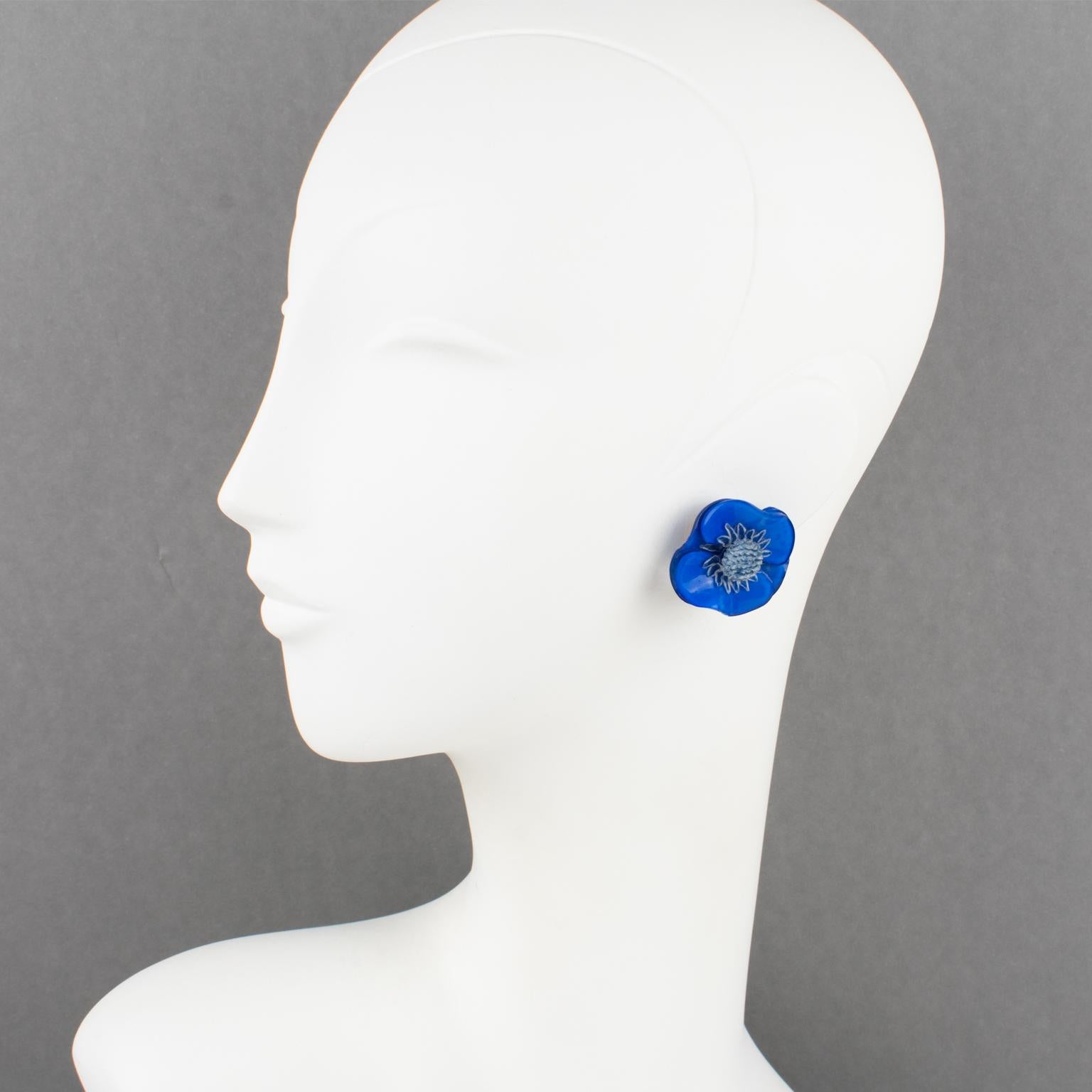 Elegant dimensional clip-on earrings designed by Cilea Paris for Francoise Montague. Floral-inspired hand-made artisanal resin earrings featuring a poppy flower with a textured heart. A very nice assorted palette of cobalt blue and periwinkle blue.