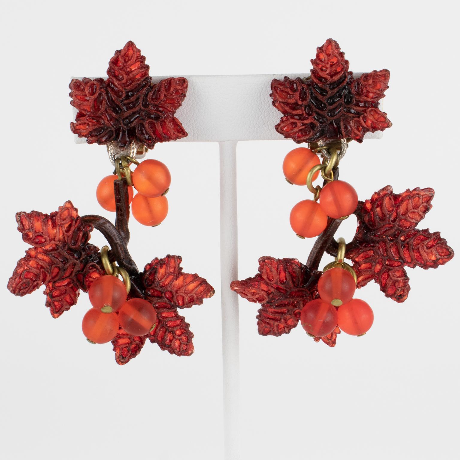 Cilea Paris designed those charming resin clip-on earrings for French jewelry designer Francoise Montague. The pieces feature a dangling shape, all carved and textured, with vine leaf and cluster grape designs in rust and amber colors. 
As usual,