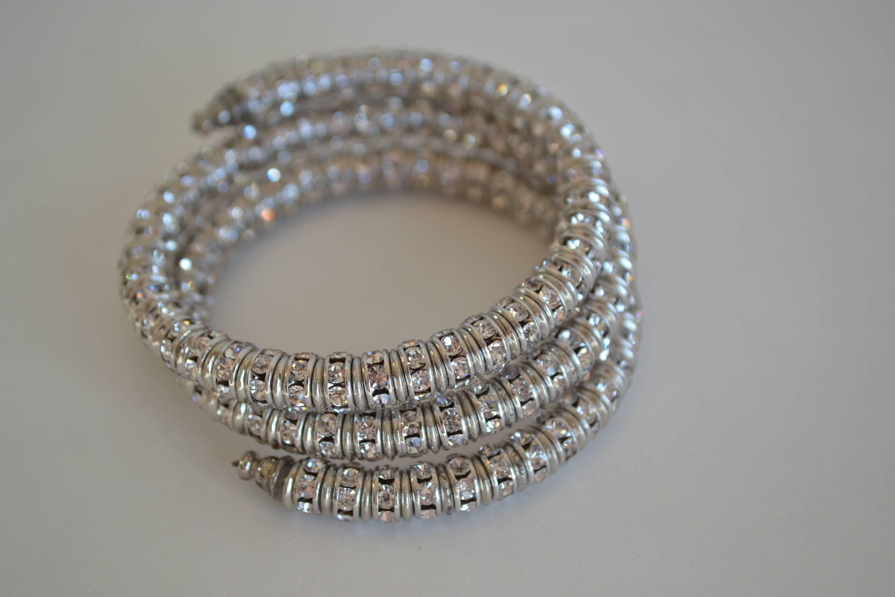 Memory wire wrap bracelet with clear Swarovski crystal rondelles from Francoise Montague. Fits most wrists both large and small and is easy to take on and off.

Francoise Montague took over the De Saurma jewelry workshop in the late 1940s. Her