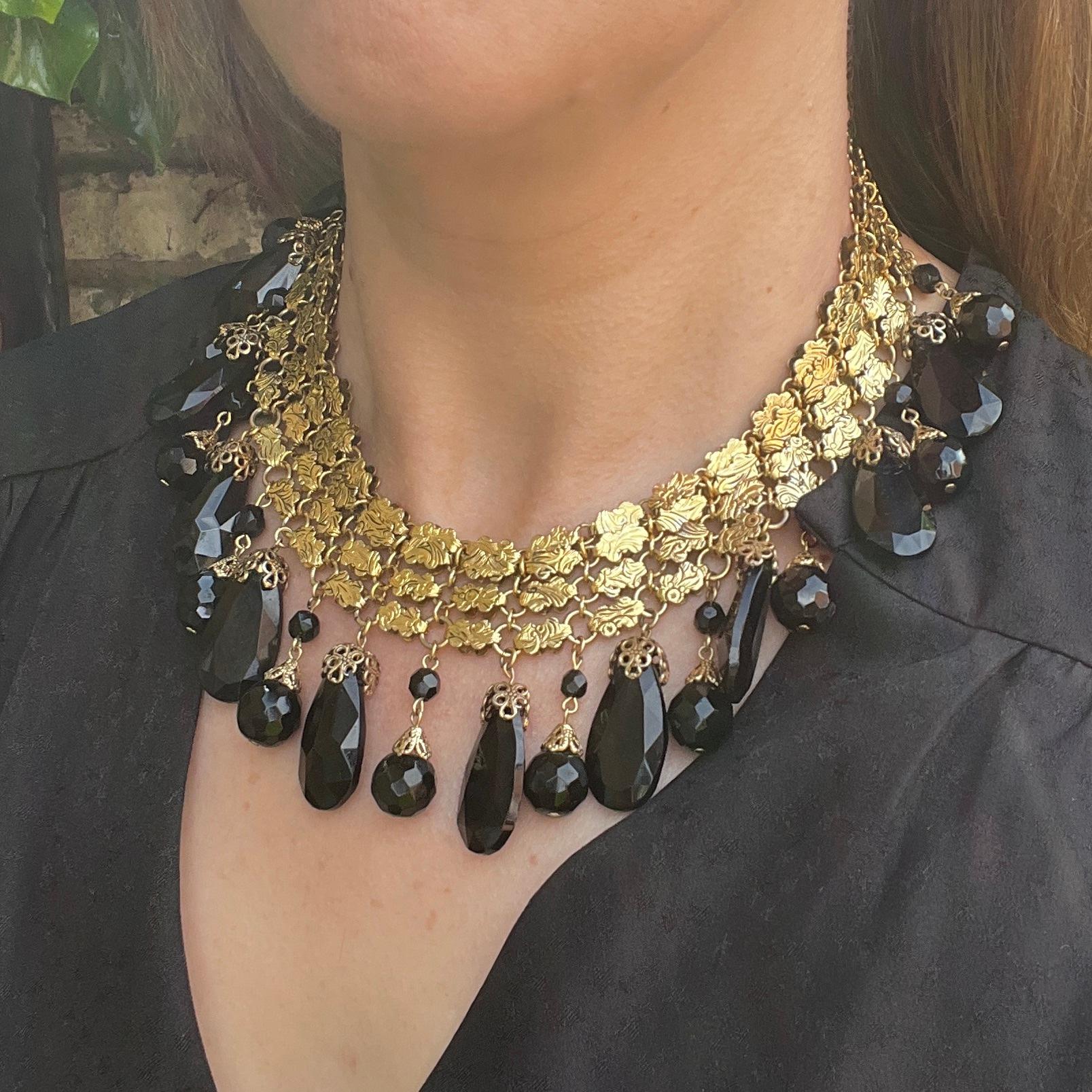 This wonderful example of Françoise Montague jewellery dates from c.1962. 

Condition Report:
Excellent 

The Details...
This collar necklace is constructed from 4 rows of gilded metal links all stamped with floral patterns. Suspended from the full