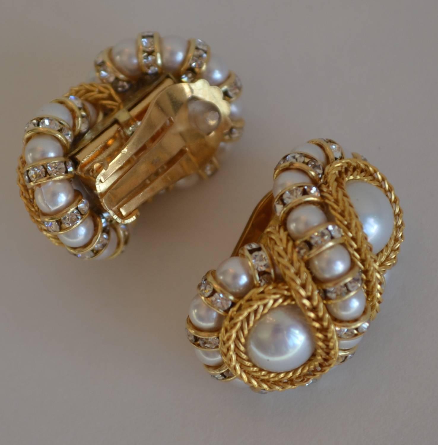 Glass pearl clip earrings in a figure 8 shape with gold chain and Swarovski crystal rondelles from Francoise Montague.

Francoise Montague took over the De Saurma jewelry workshop in the late 1940s. Her mother founded the workshop in 1945, according