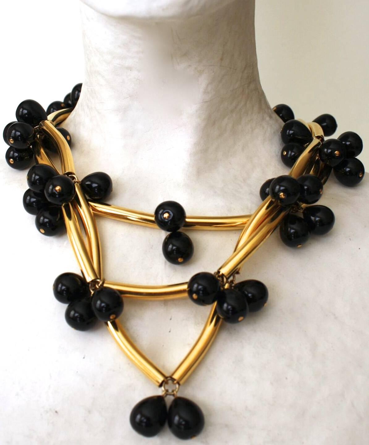 An Isabelle K Jewelry best seller! This famous necklace from Francoise Montague is made with tubes in a gold metallic treatment and black handmade glass pearls. 

As seen in the book Les Paruriers, Bijoux de le Haute Couture

16