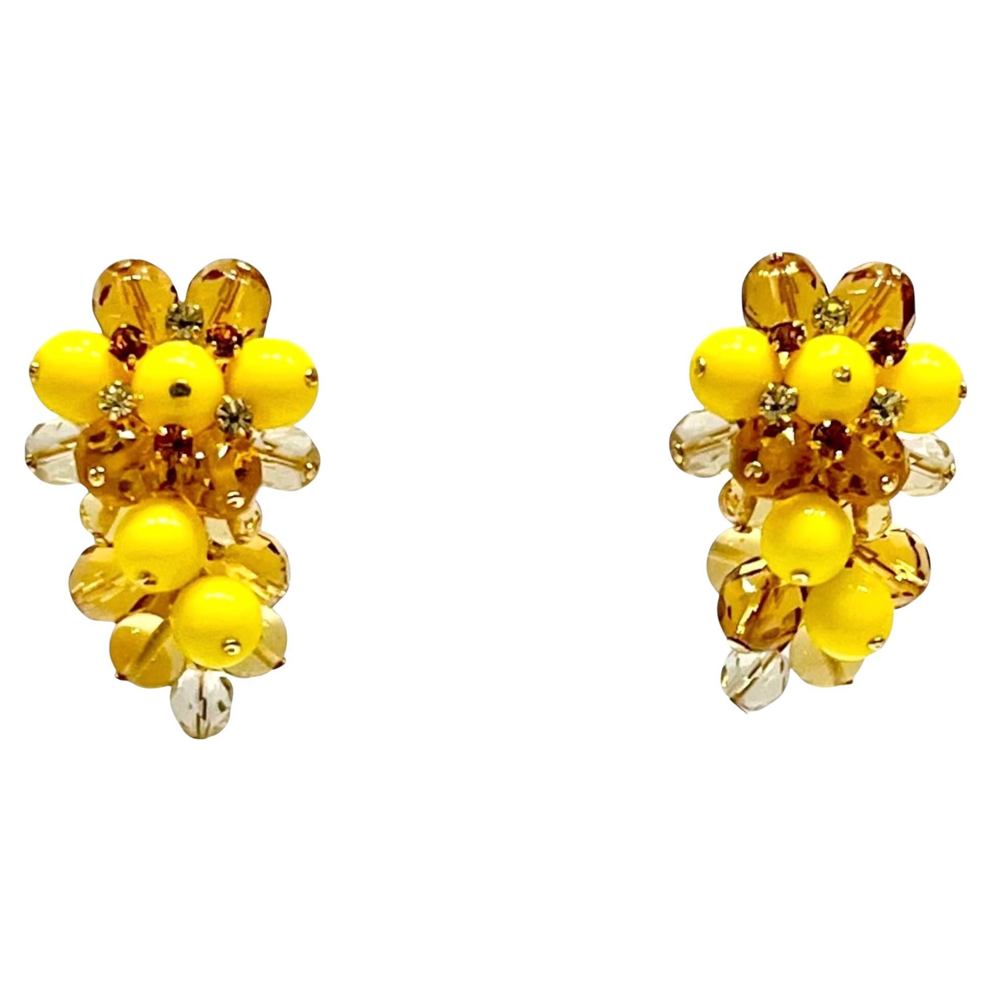 Green and  glass beads clip earrings inspired after a bunch of grapes from French design house Francoise Montague. 
Francoise Montague took over the De Saurma jewelry workshop in the late 1940s. Her mother founded the workshop in 1945, according to